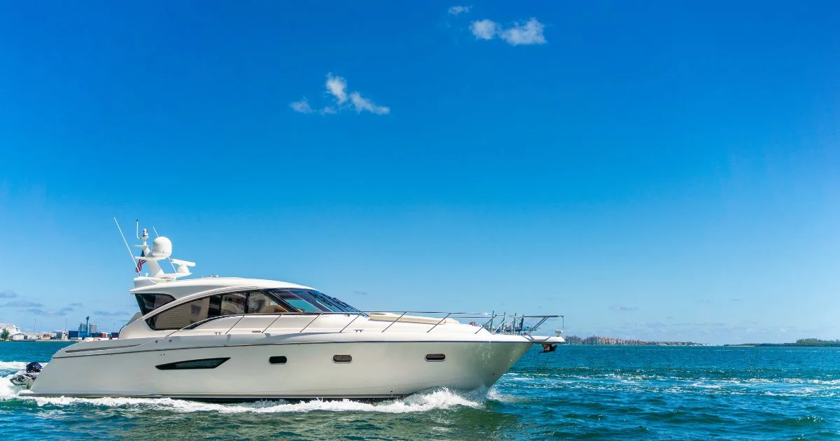 Luxury motor yacht cruising on ocean under blue sky