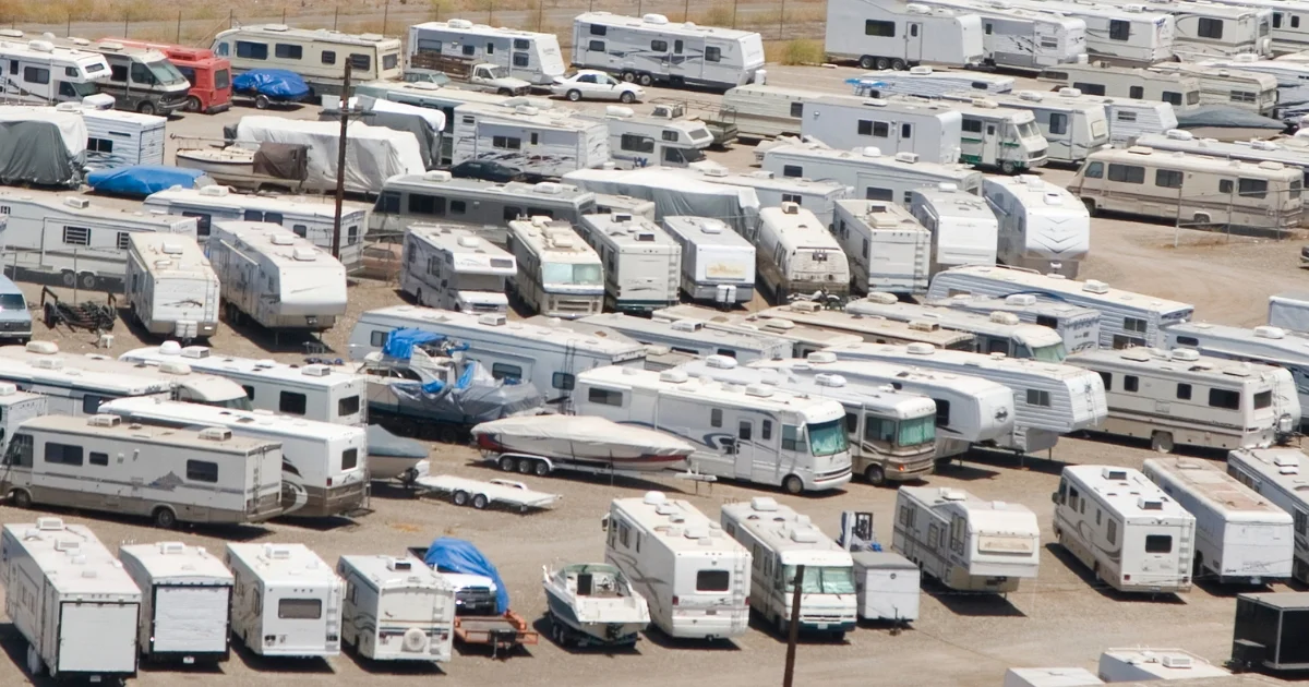 Aerial view of RVs, trailers, and boats in a large outdoor storage lot.
