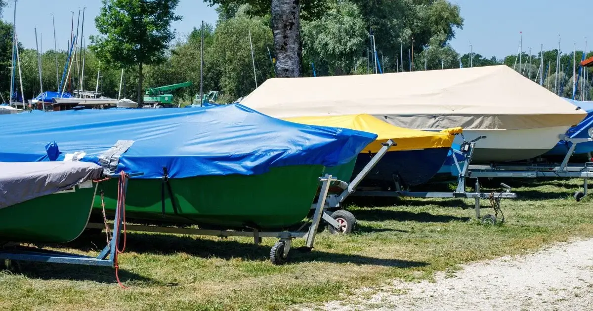Covered boats stored on trailers at outdoor marina