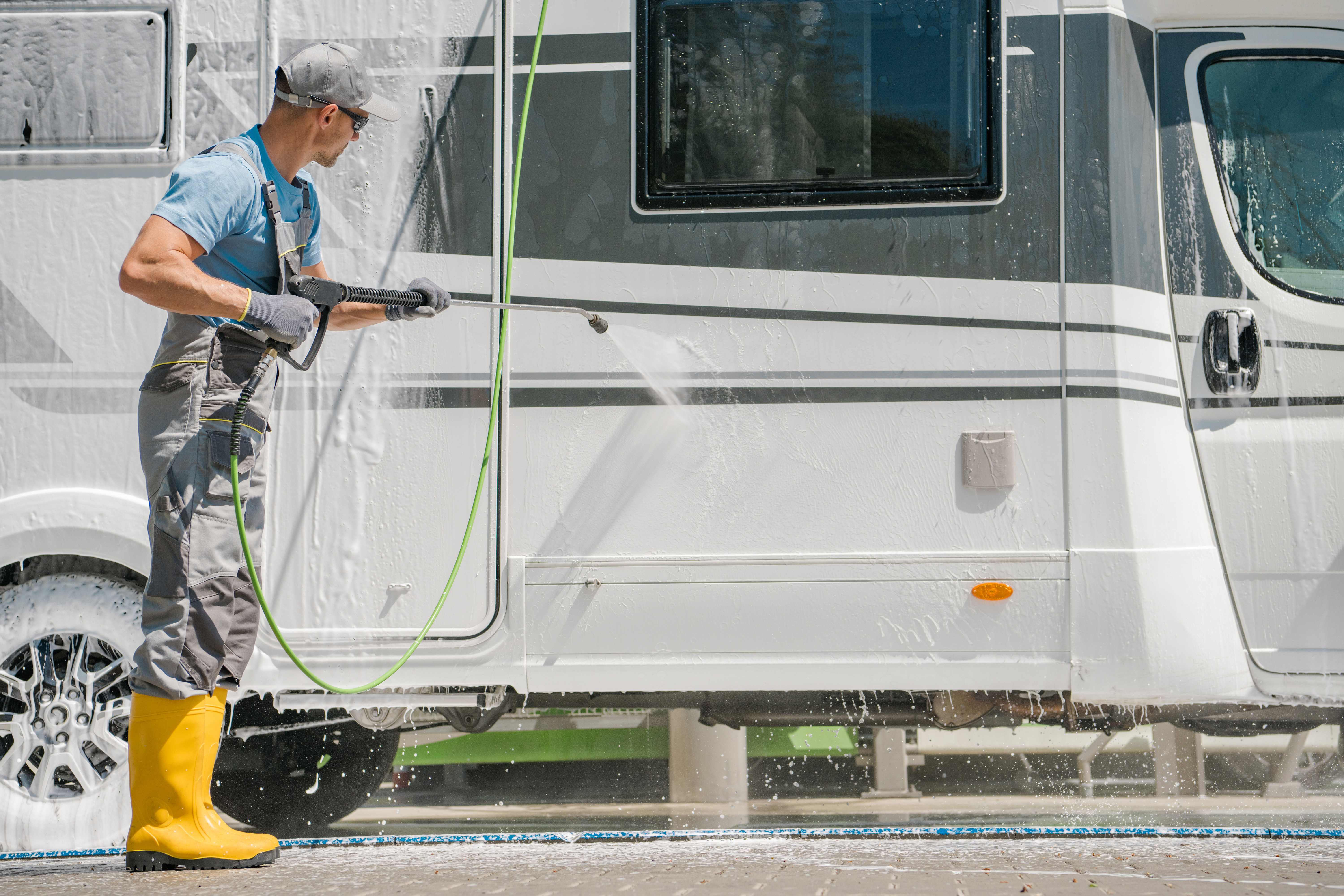 Getaway-RV-Boat-Storage - Man washing RV with pressure washer