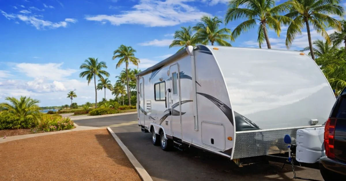 Travel trailer parked near tropical beach road
