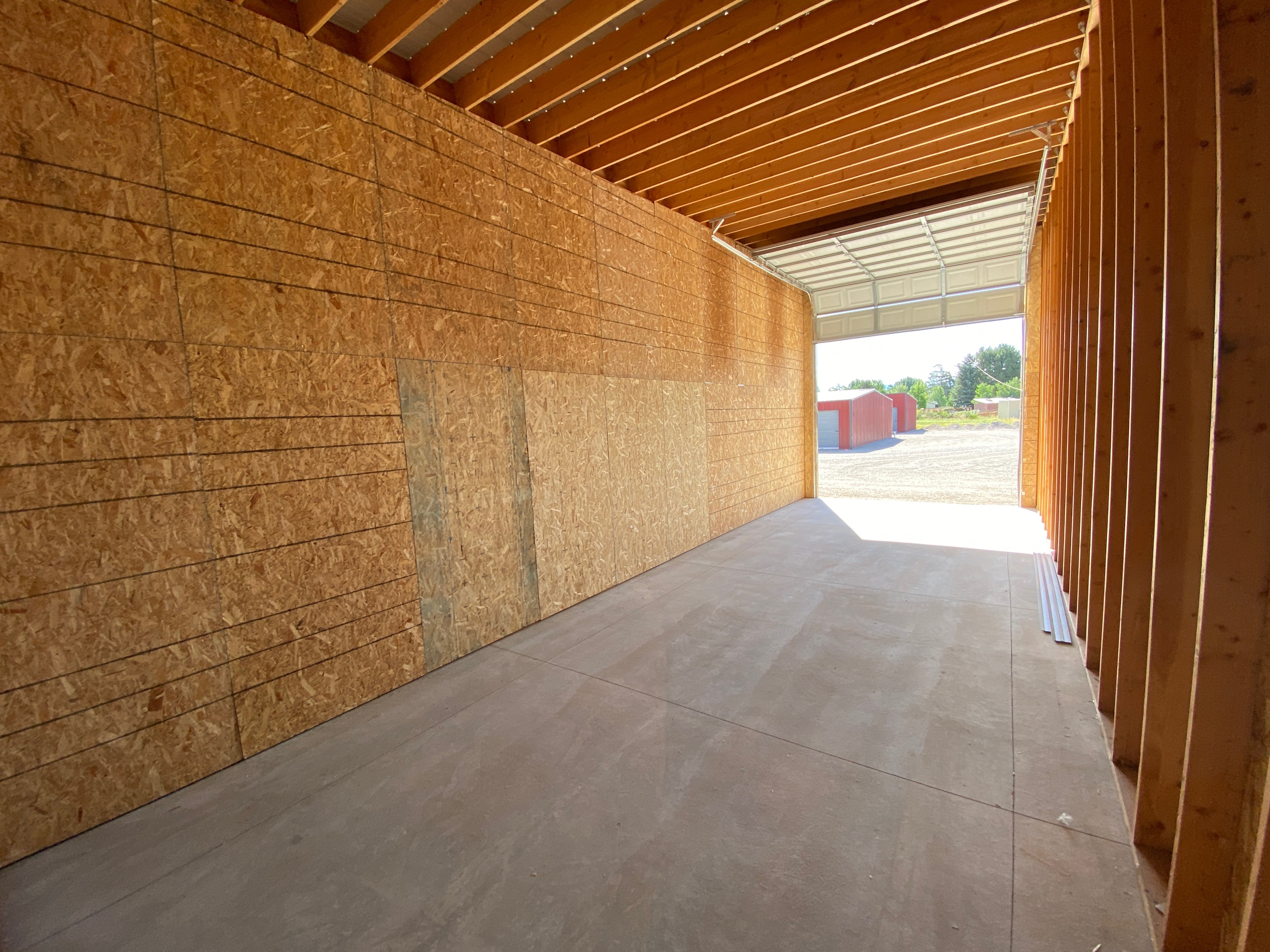 inside of an empty storage unit with an open roll up door