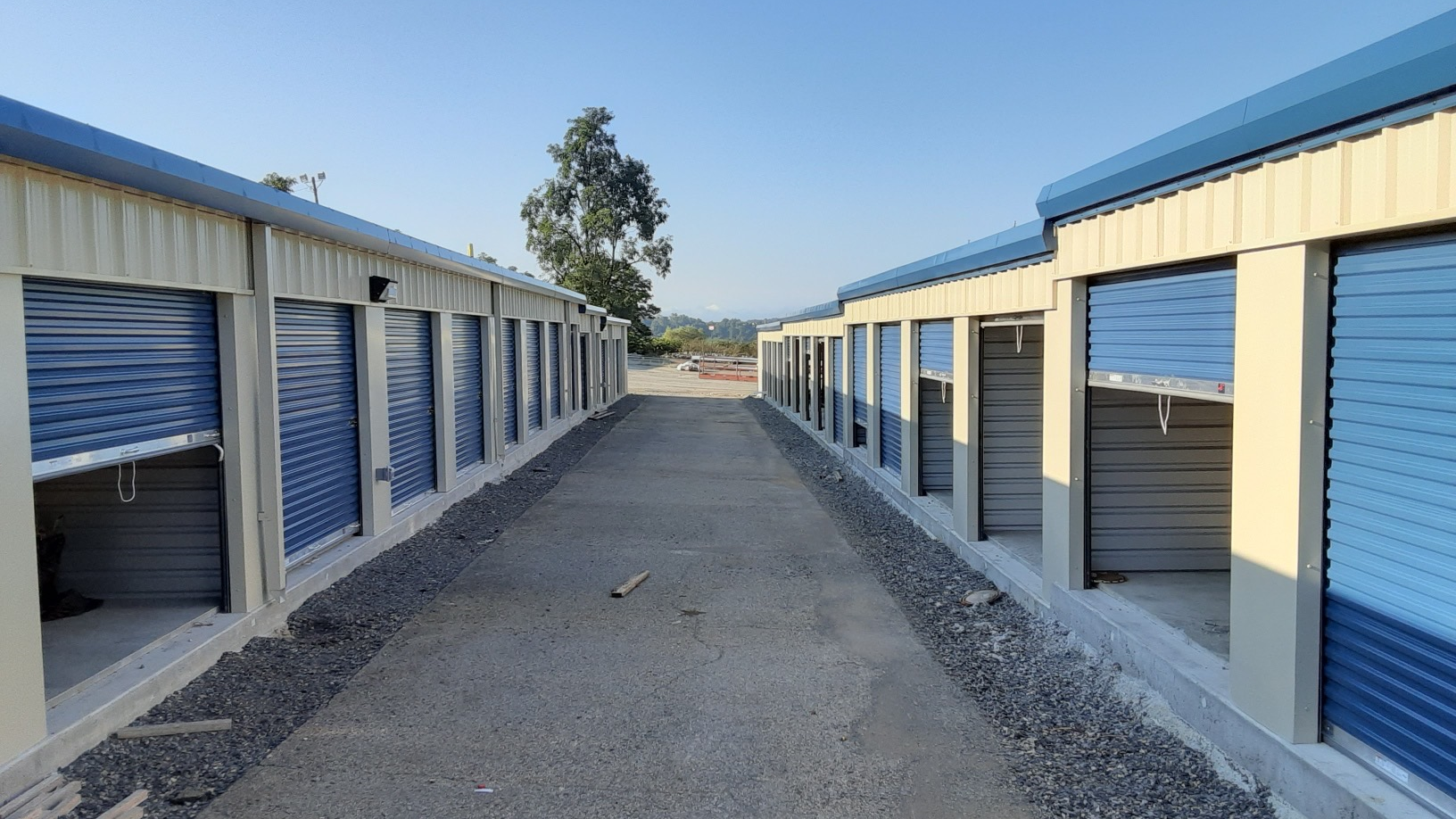 two self storage buildings with roll up doors and drive up access