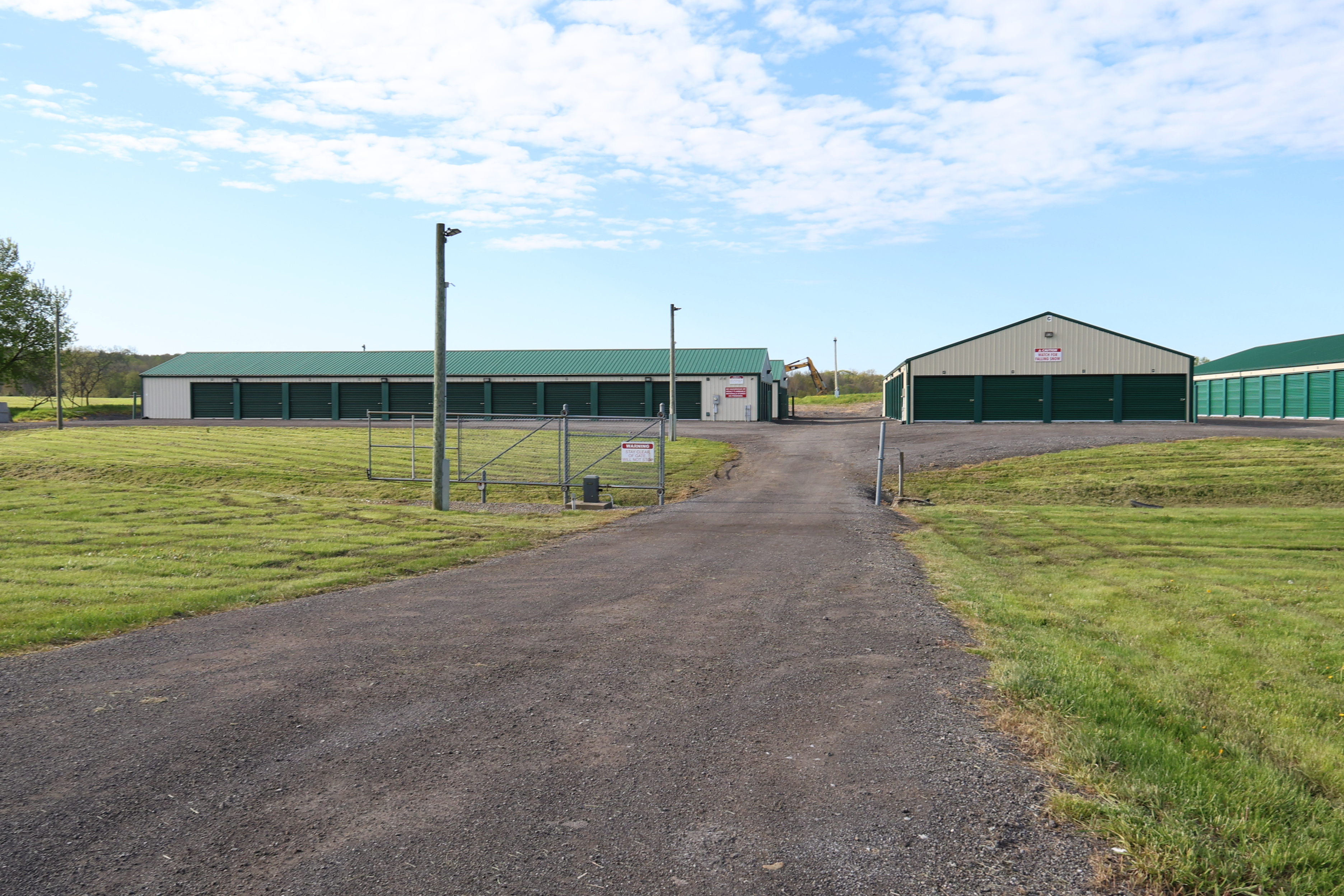 Entrance drive at A-Verdi Self Storage Darien Center leading to multiple rows of outdoor storage units