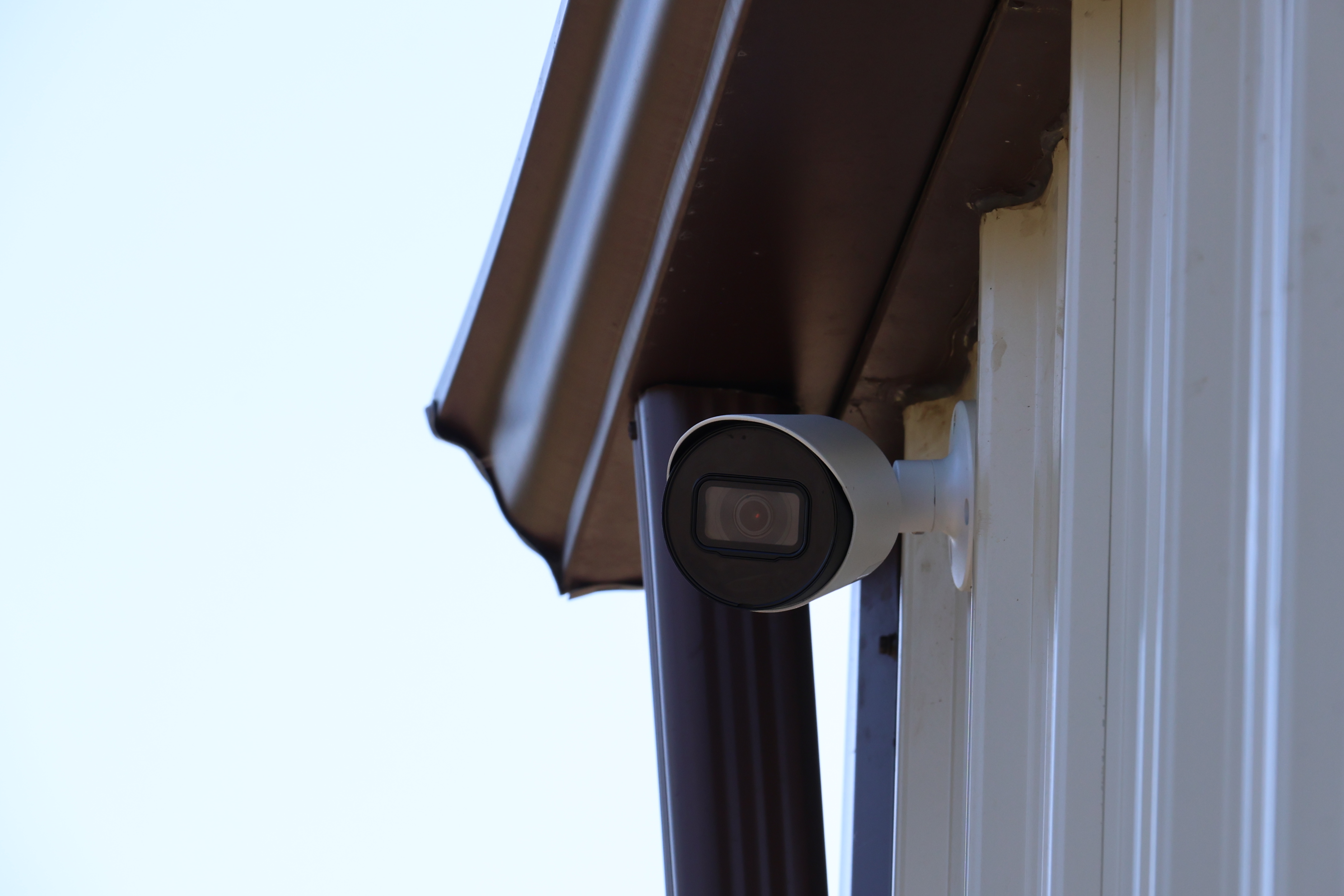 Security camera mounted on A-Verdi Self Storage Batavia building providing 24/7 video surveillance