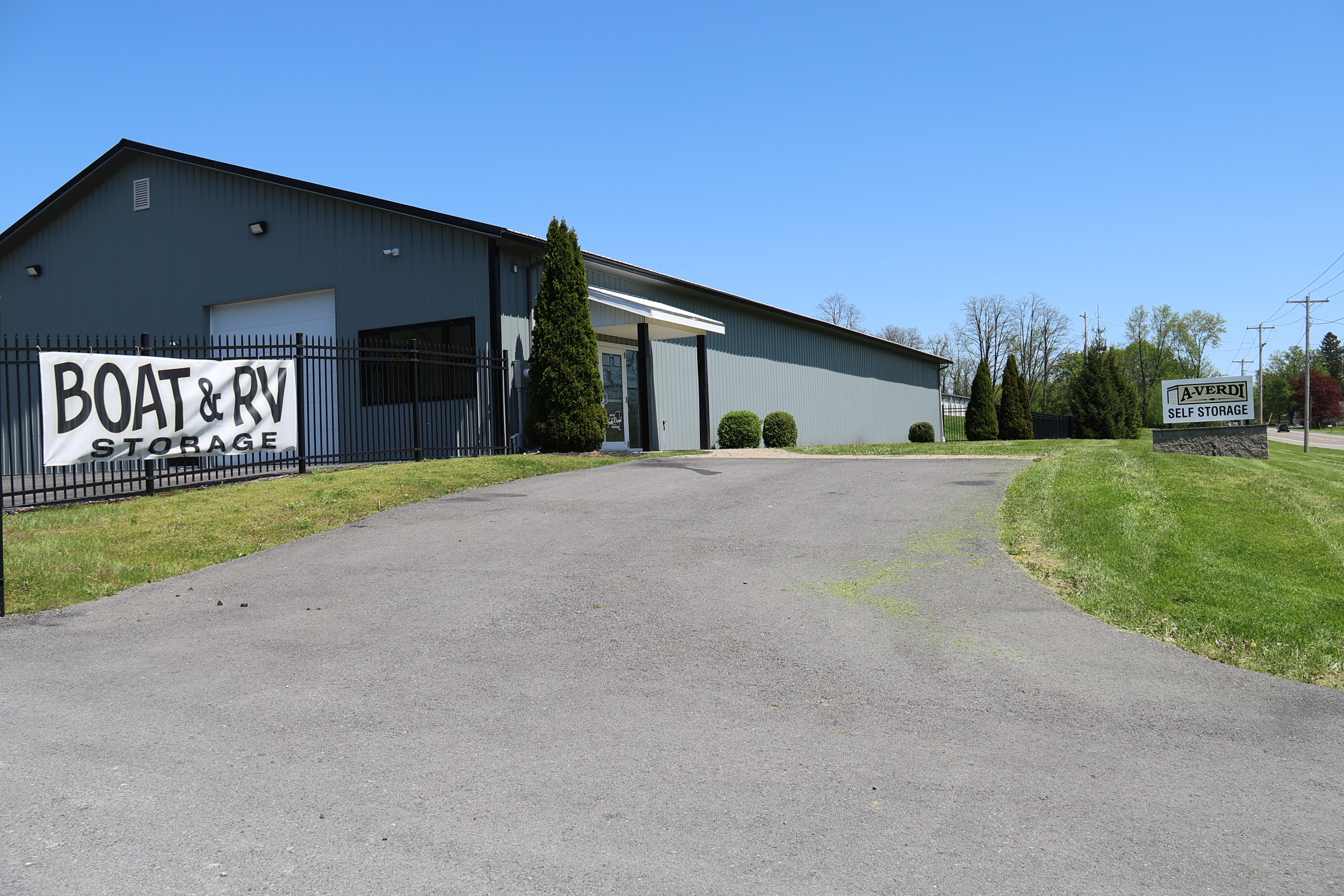 Exterior office building and driveway entrance at A-Verdi Self Storage Waterloo featuring Boat and RV storage signage