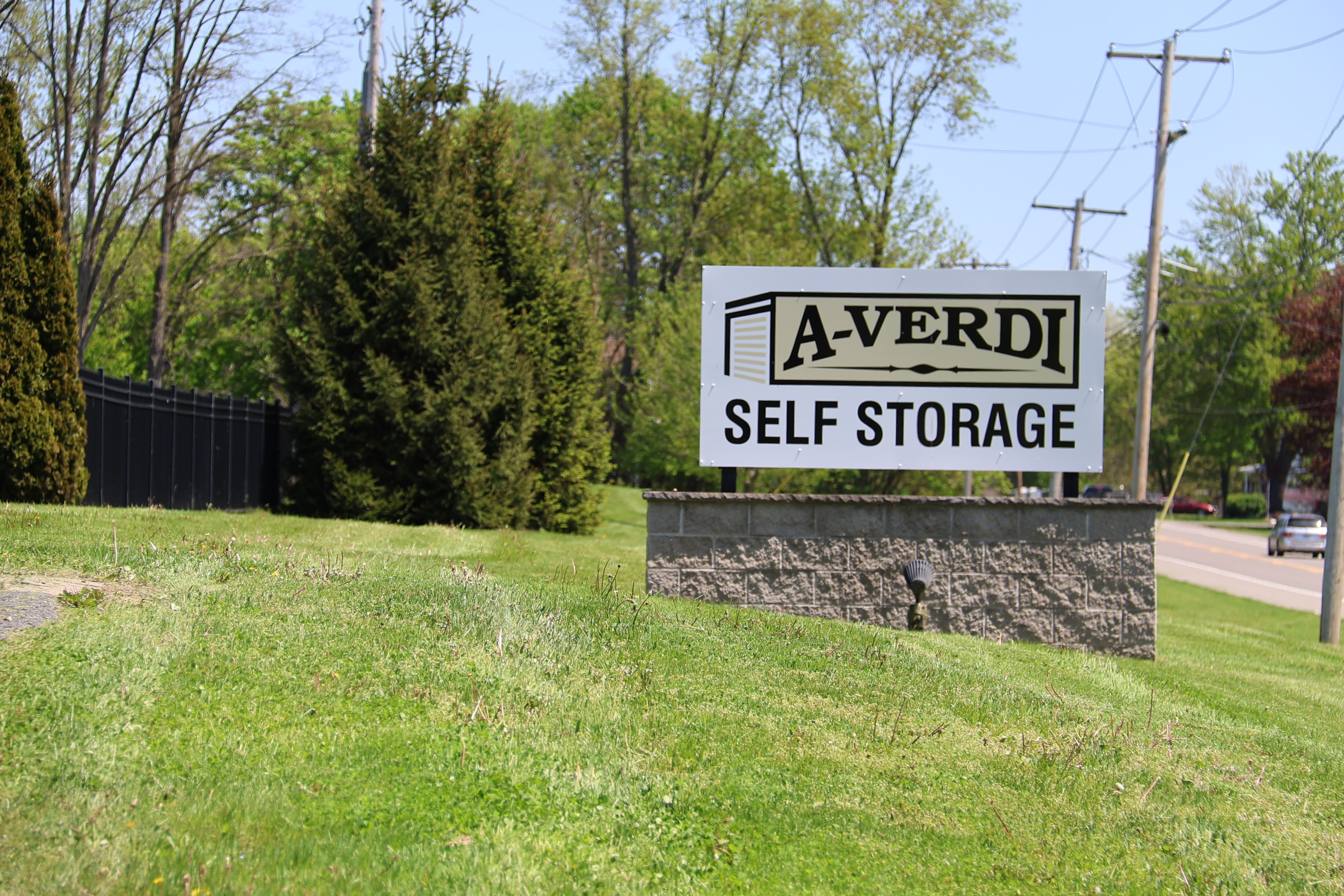 A-Verdi Self Storage Waterloo roadside sign on landscaped lawn with storage facility visible near the roadway