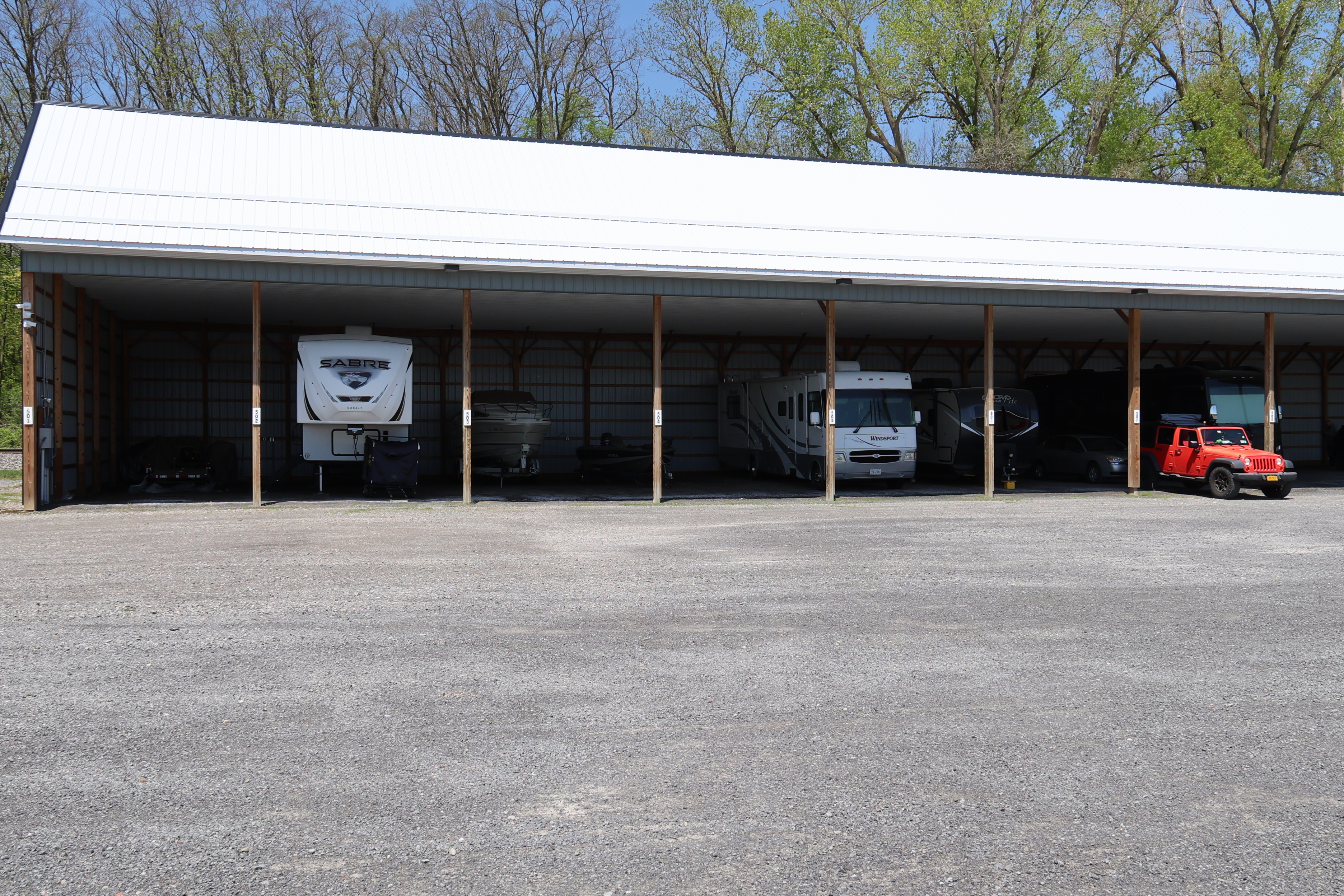 Covered boat and RV storage at A-Verdi Self Storage Waterloo with large canopy structure and gravel parking area