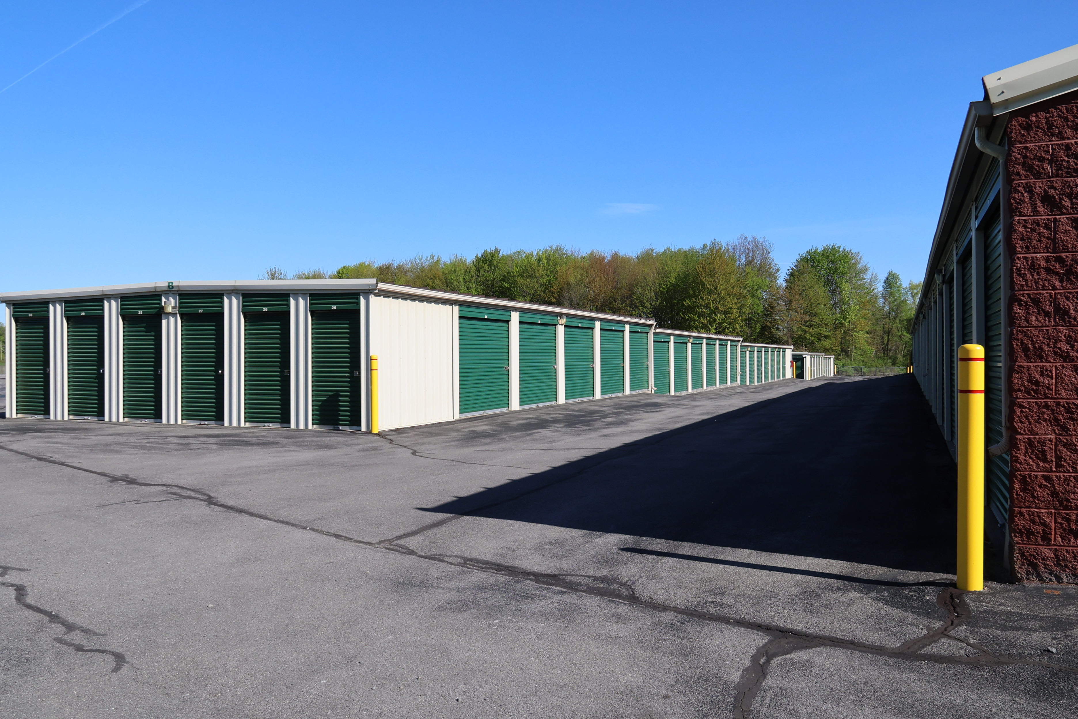 Drive-up self storage units at A-Verdi Self Storage Baldwinsville with wide paved access and green doors