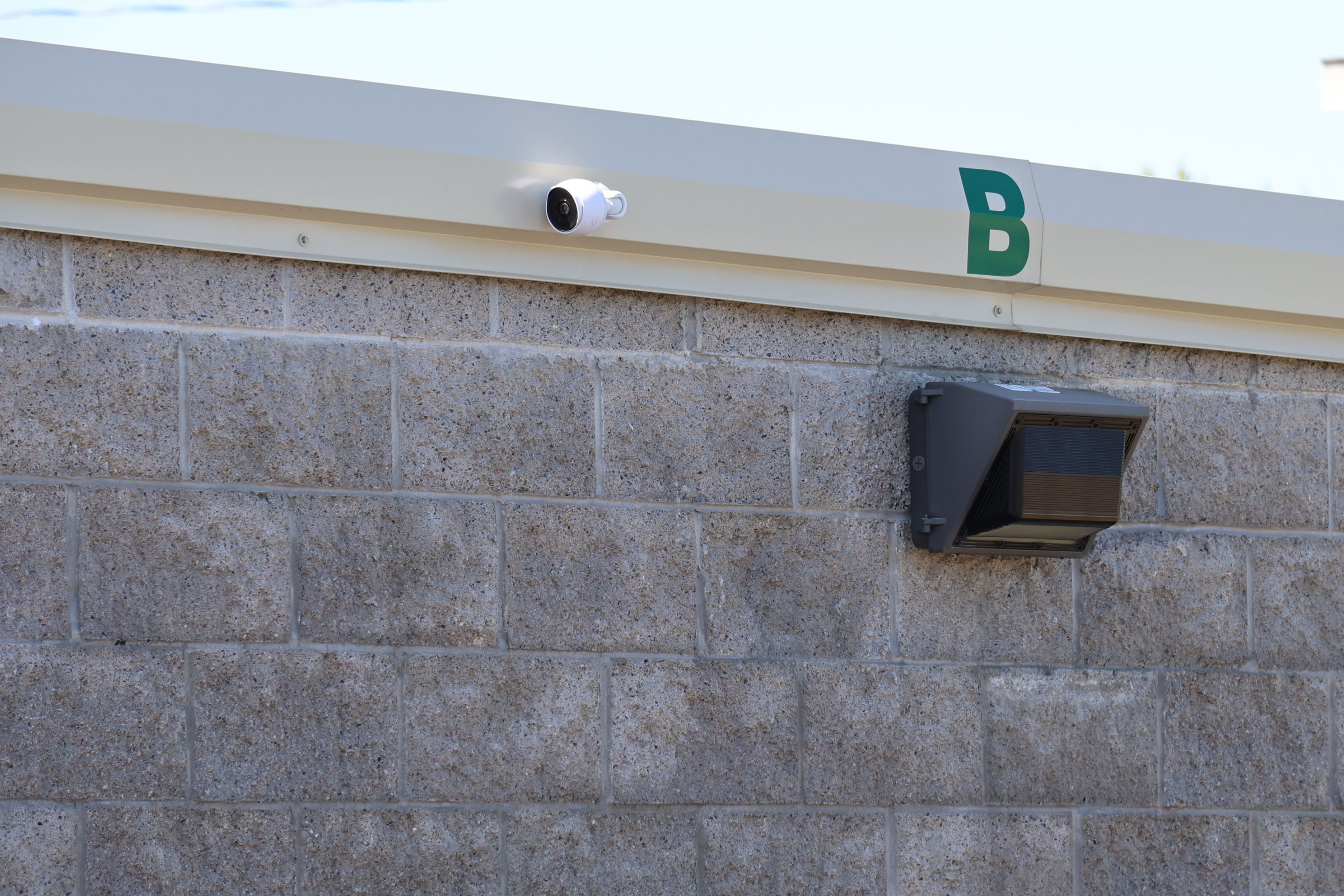 Security camera mounted on A-Verdi Self Storage Clay building providing 24/7 video surveillance