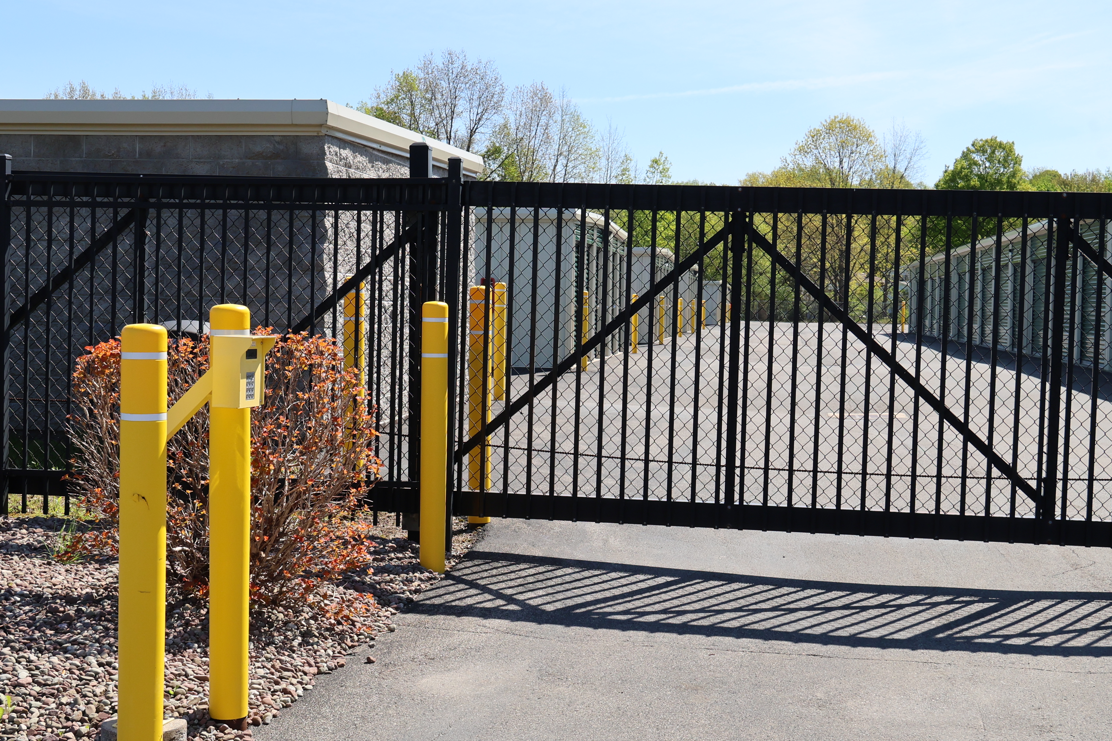 Secure gated entrance at A-Verdi Self Storage Clay with keypad access, perimeter fencing, and controlled entry