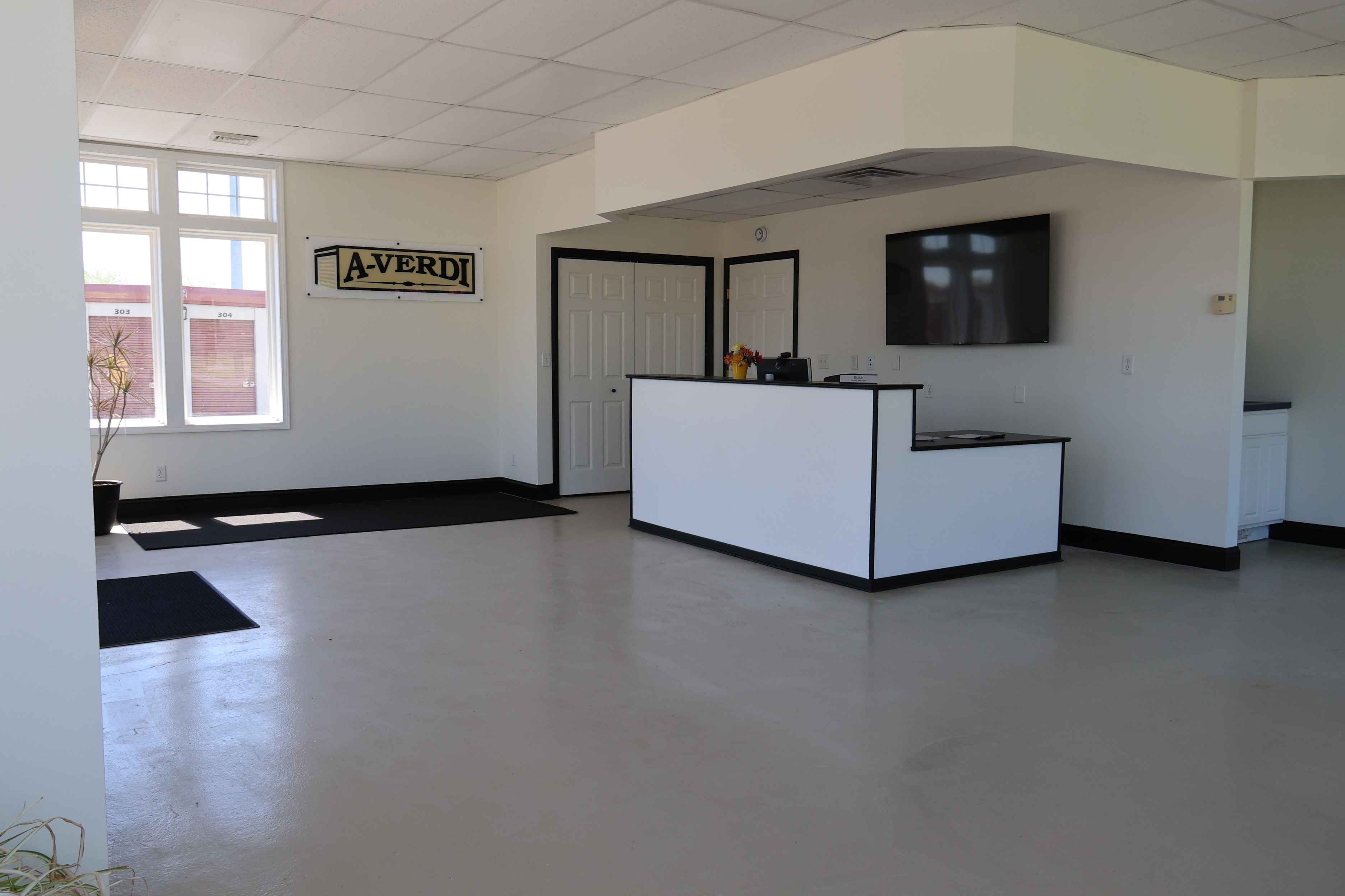Interior of the A-Verdi Self Storage Marcy office featuring customer service desk and waiting area