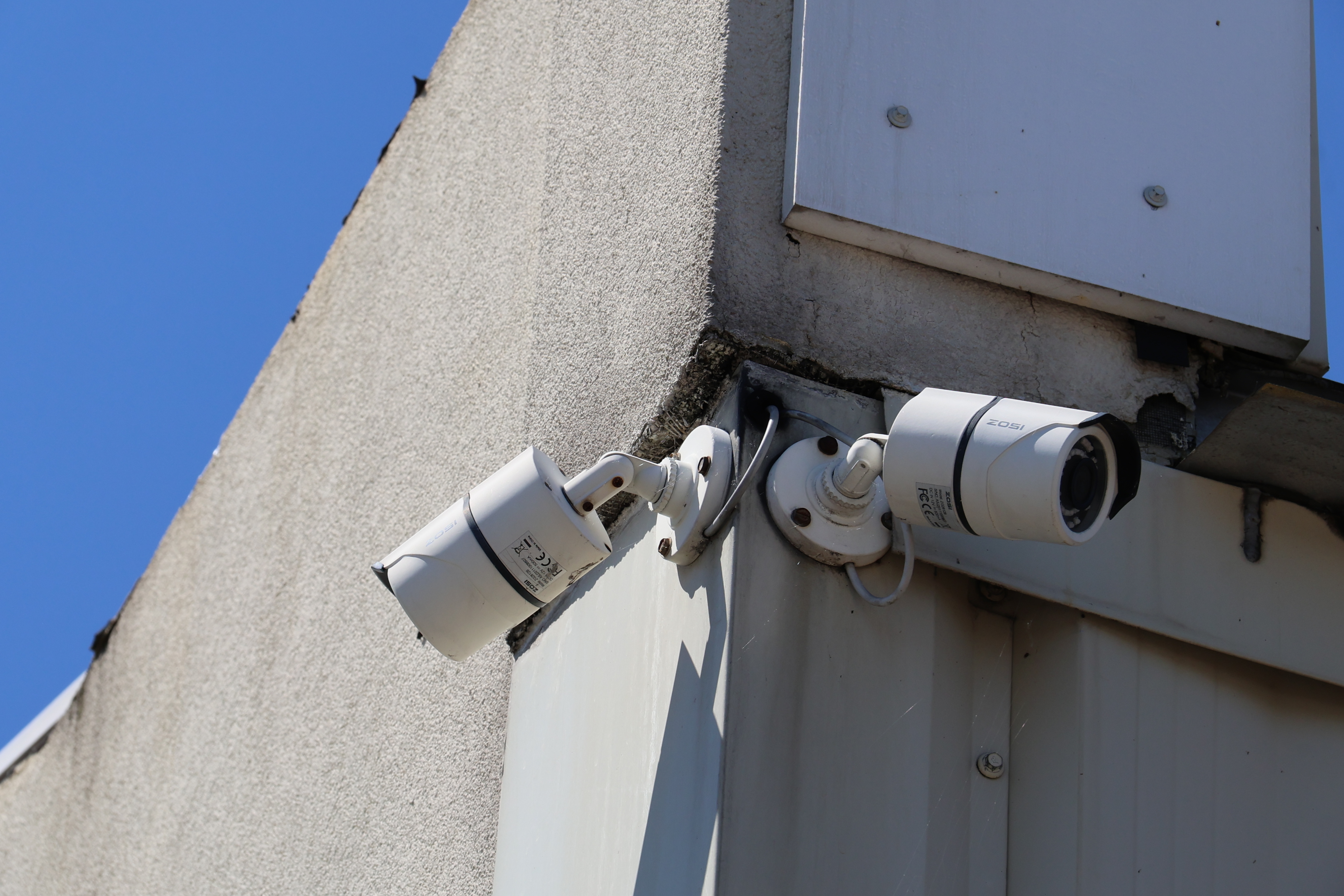 Exterior security cameras mounted on A-Verdi Self Storage Utica building monitoring the facility perimeter
