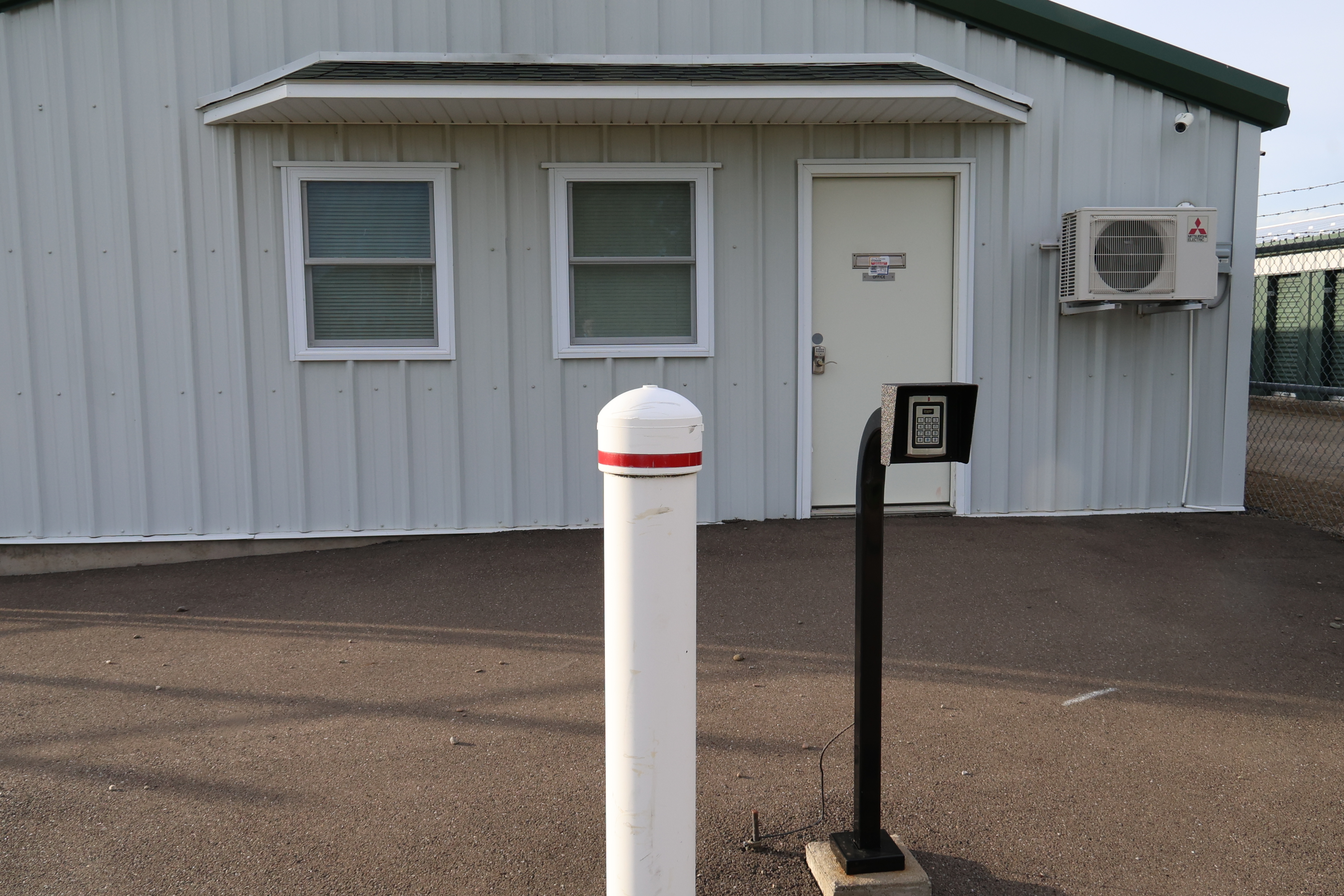 Exterior of the A-Verdi Self Storage Corning office with keypad access system and customer entry door
