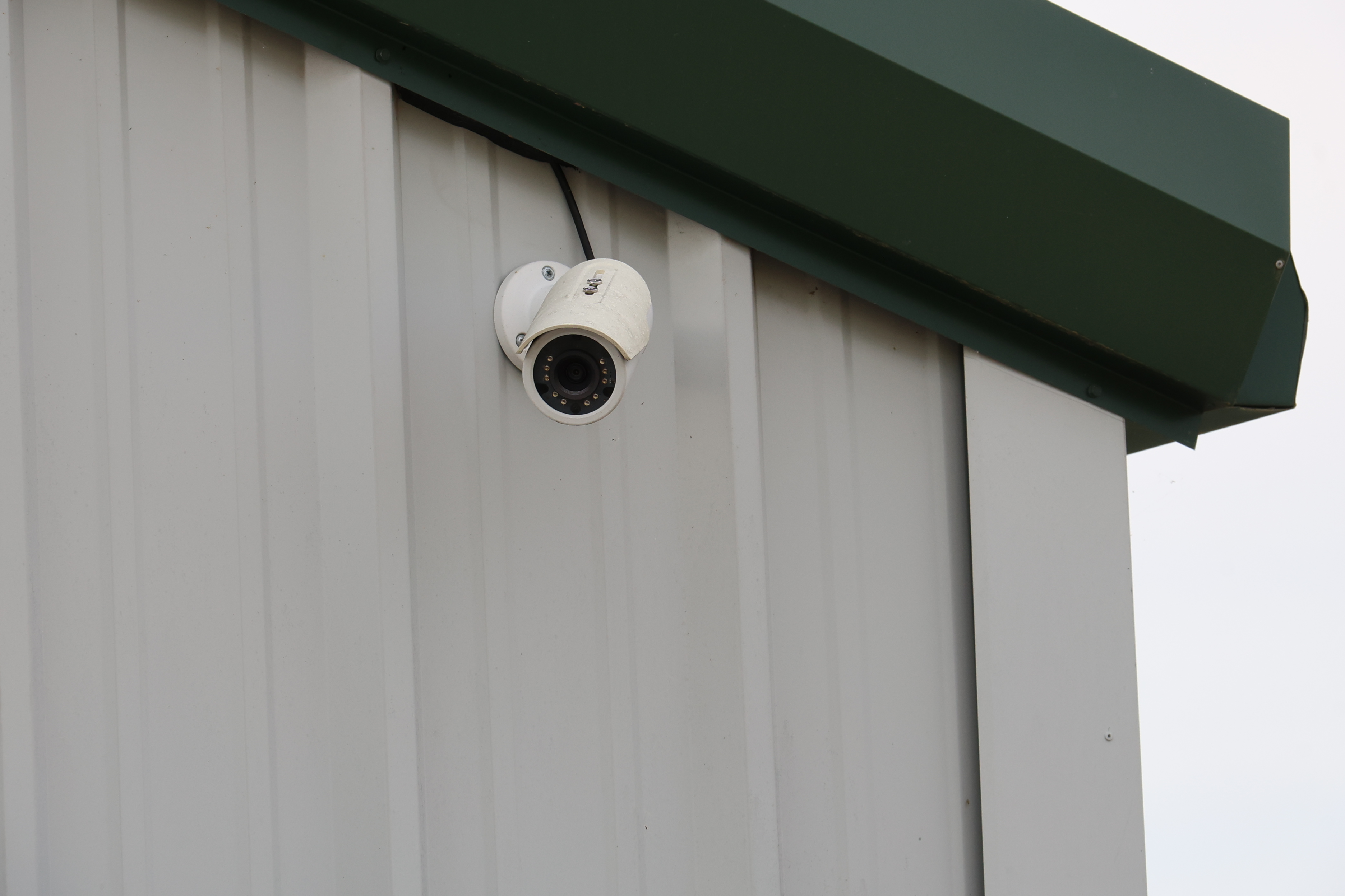 Security camera mounted on A-Verdi Self Storage Corning building providing 24/7 video surveillance