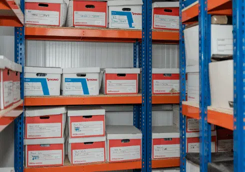 document boxes stacked on shelves in a self-storage unit