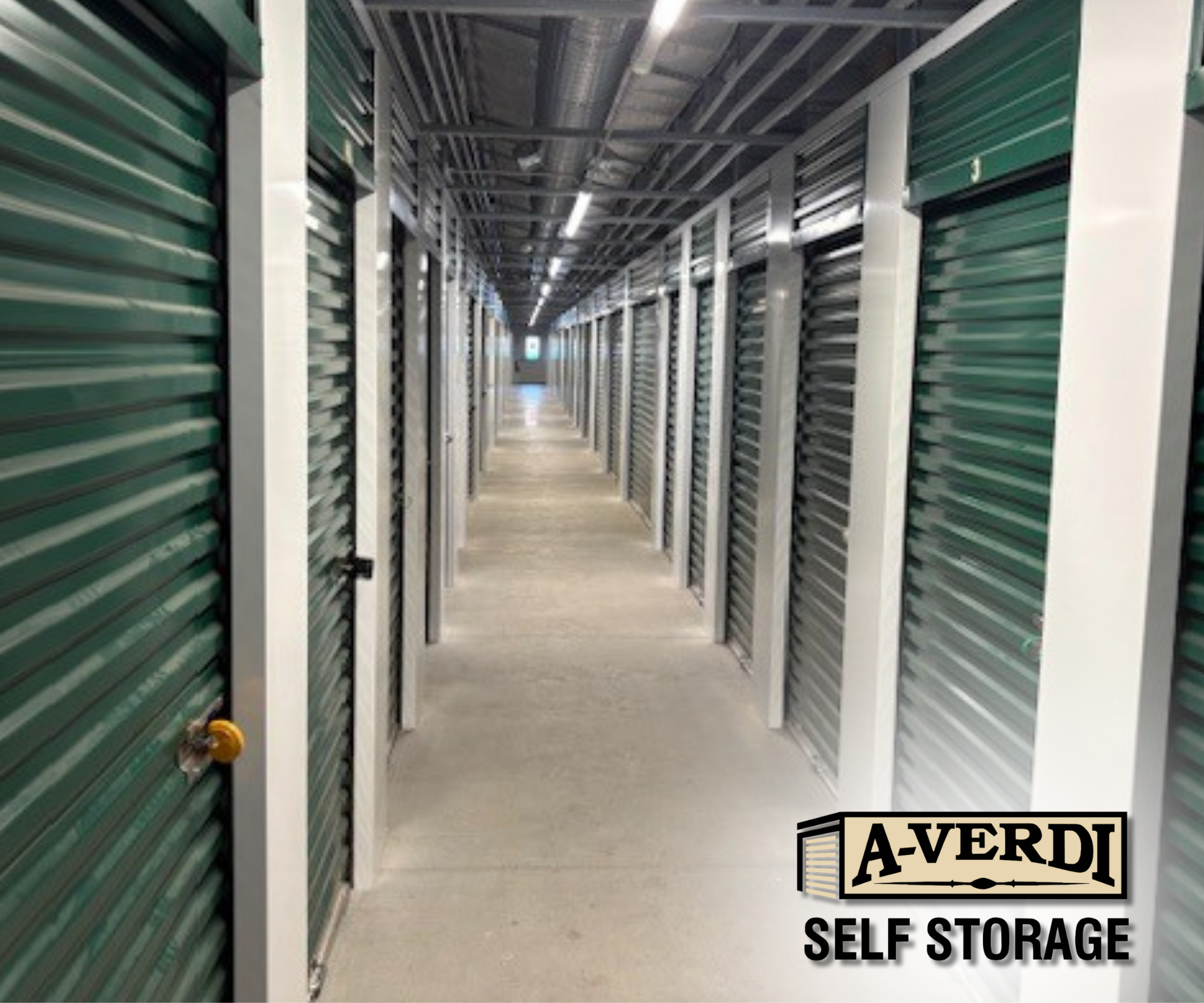Interior hallway of A-Verdi Self Storage facility with clean, well-lit storage units and secure roll-up doors