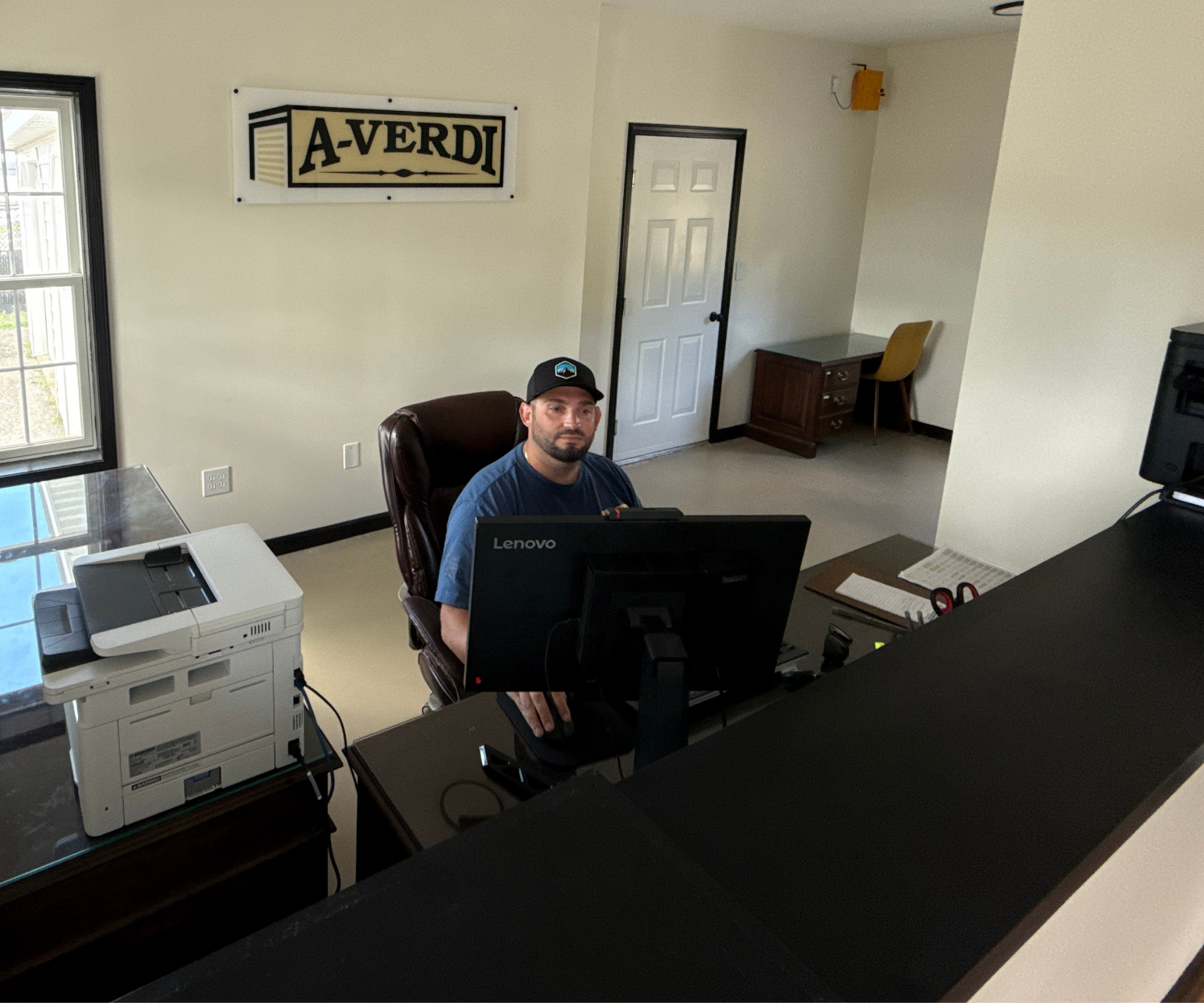 A-Verdi Self Storage employee sitting at the customer service desk of the Glenmont facility
