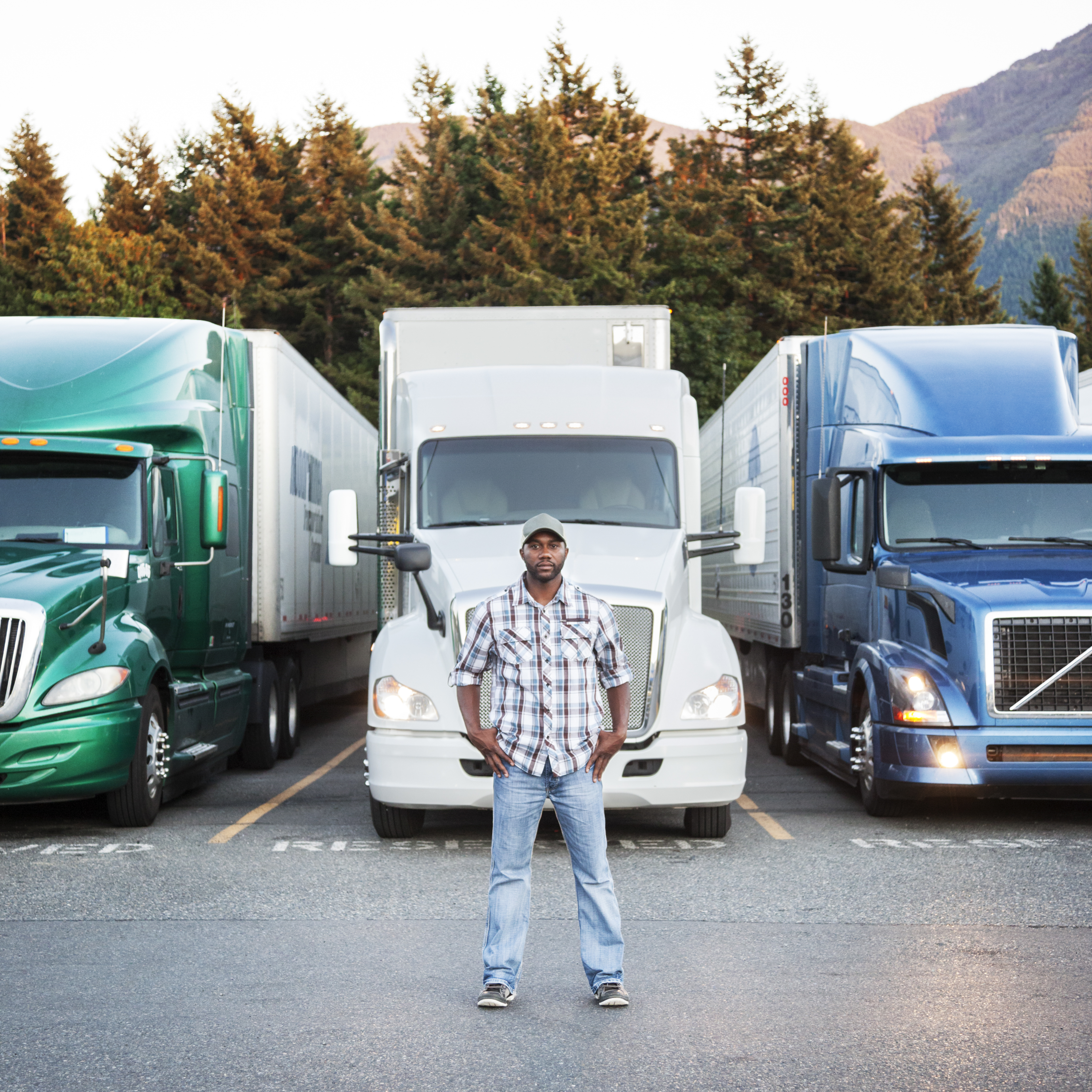 semi-truck driver standing outside of vehicle