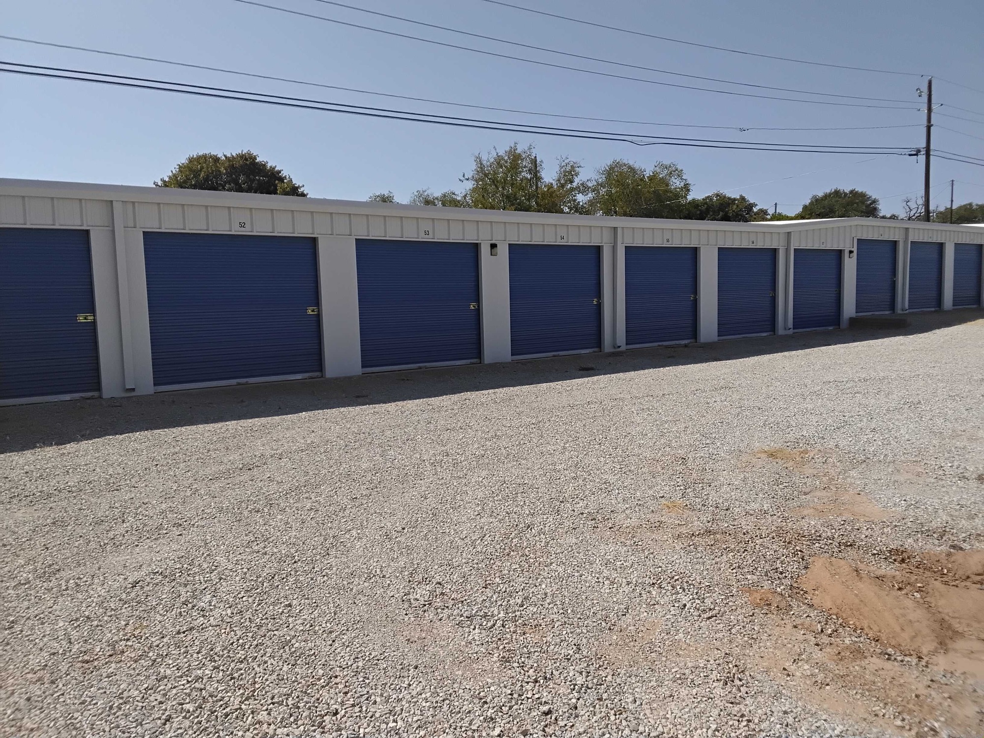 Row of blue drive-up storage units at Bigfoot Storage on N Victory in Graham, TX