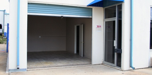 storage space converted into office space, open roll up door, painted interior, finished floor