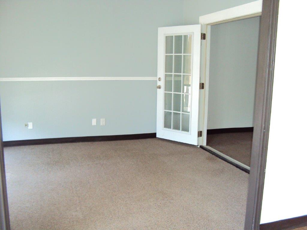 carpeted office space with windowed doors