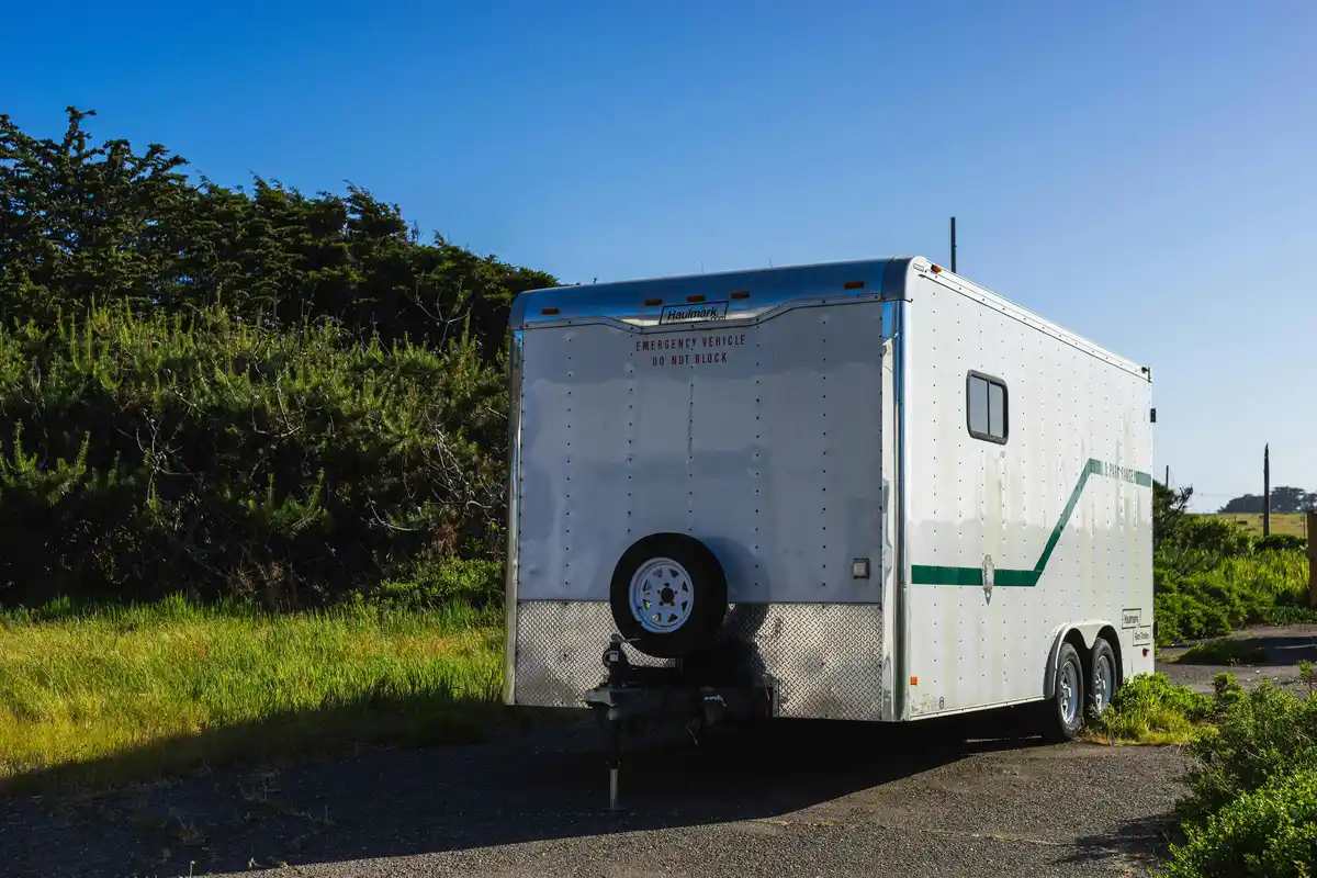 Trailer parked next to a grassy spot