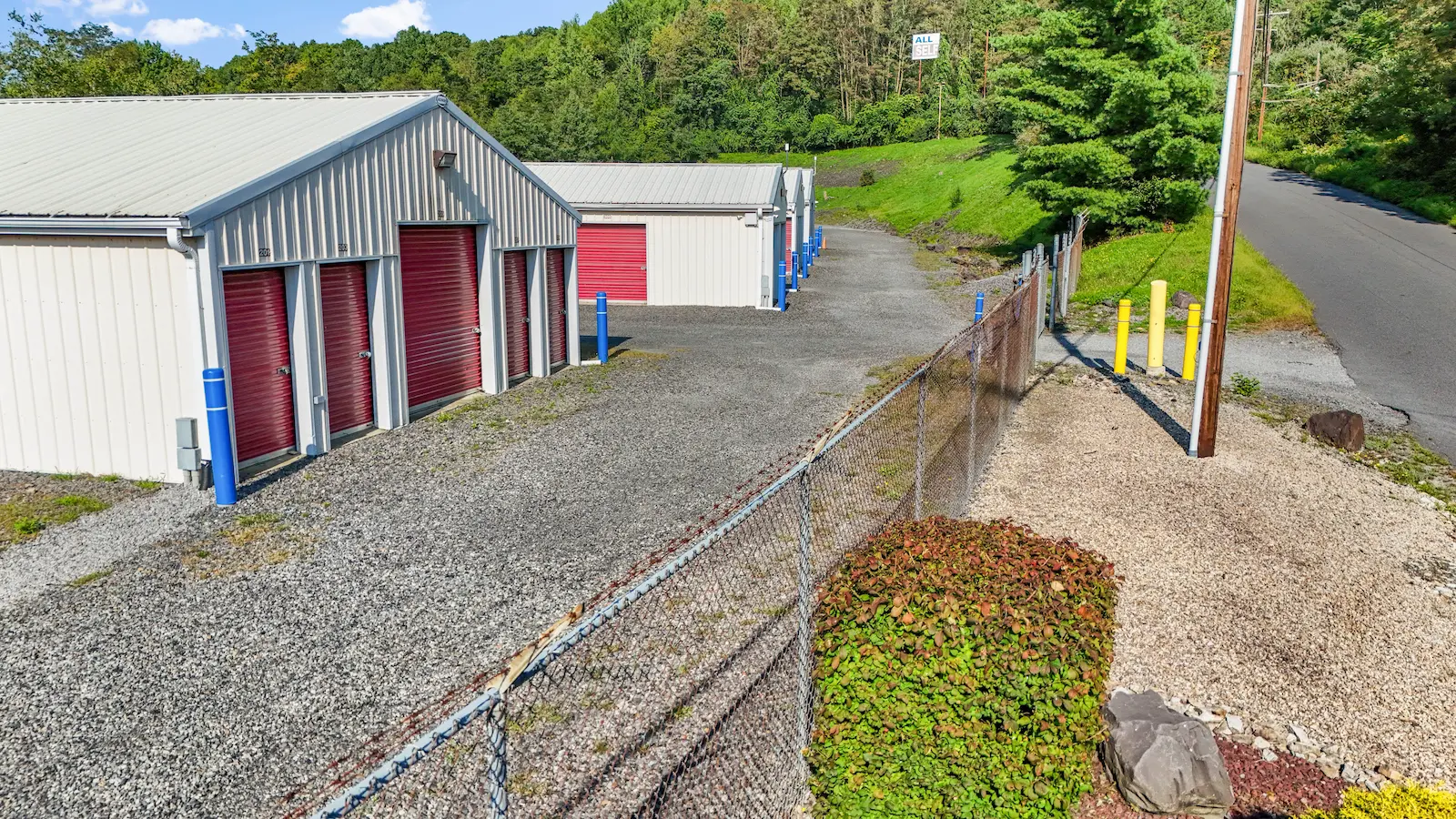 Multiple storage buildings at UrbanLock Scranton with various unit sizes, secure perimeter fencing, landscaped grounds, and clear drive-up access lanes