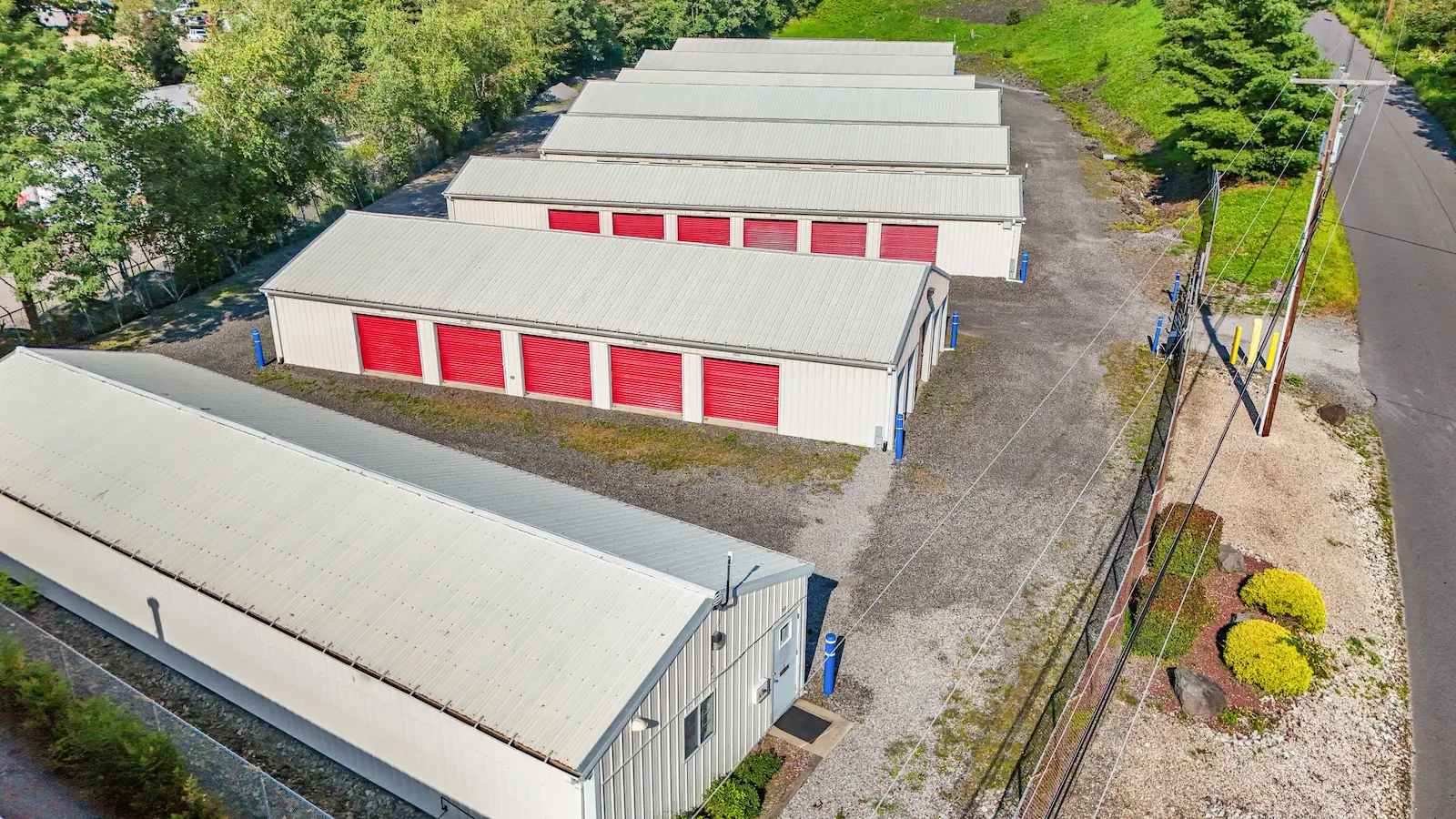 Aerial view of UrbanLock self-storage facility in Scranton with office building in foreground and storage buildings visible, surrounded by landscaping and wooded property