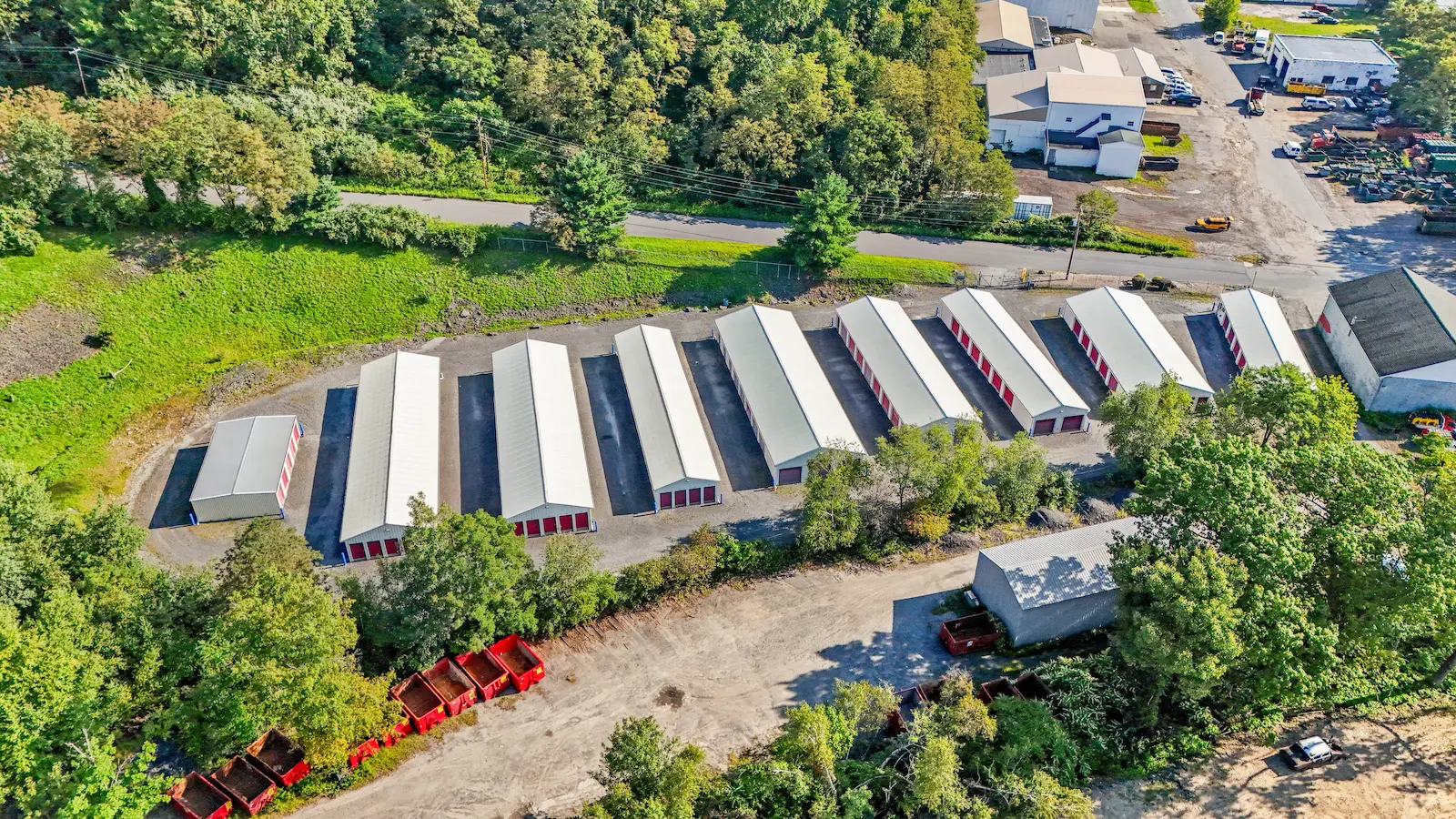 Aerial view of UrbanLock self-storage facility in Scranton showing organized storage unit rows, wooded surroundings, and adjacent industrial properties