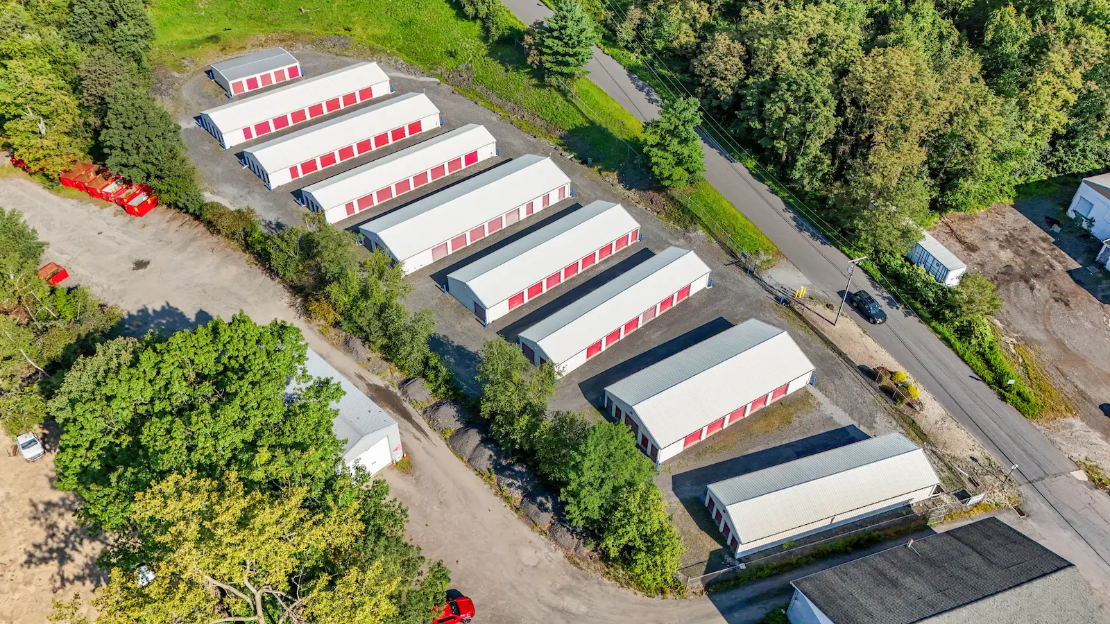 Aerial view of UrbanLock self-storage facility in Scranton showing full campus of drive-up storage units nestled in wooded setting with road access