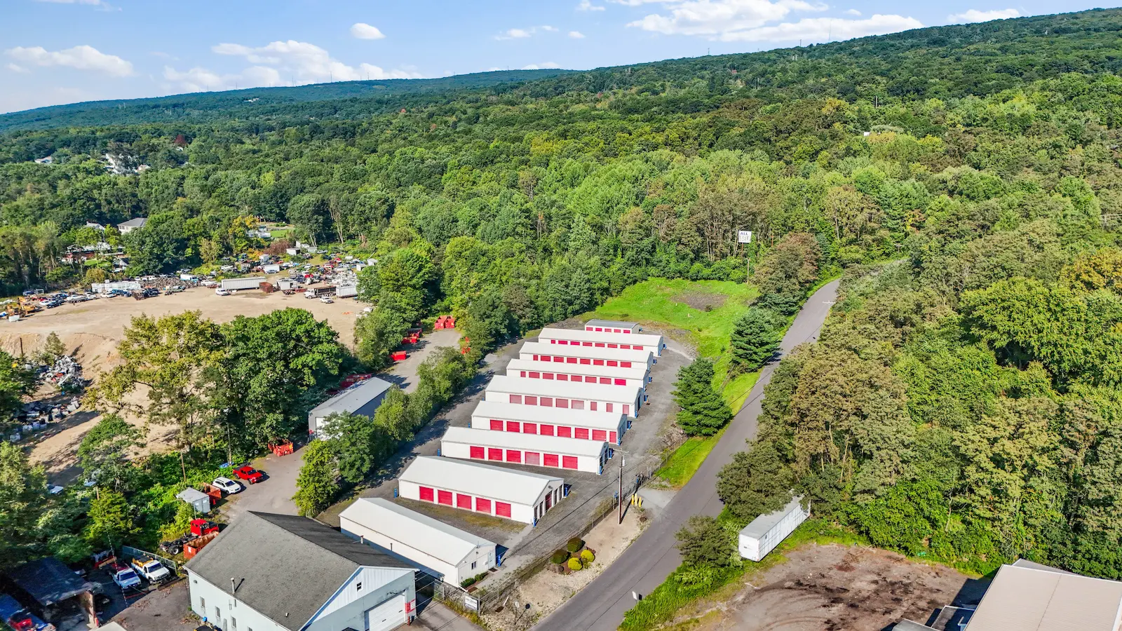 Aerial view of UrbanLock self-storage facility in Scranton nestled in rolling hillside terrain with storage buildings visible among surrounding forested landscape