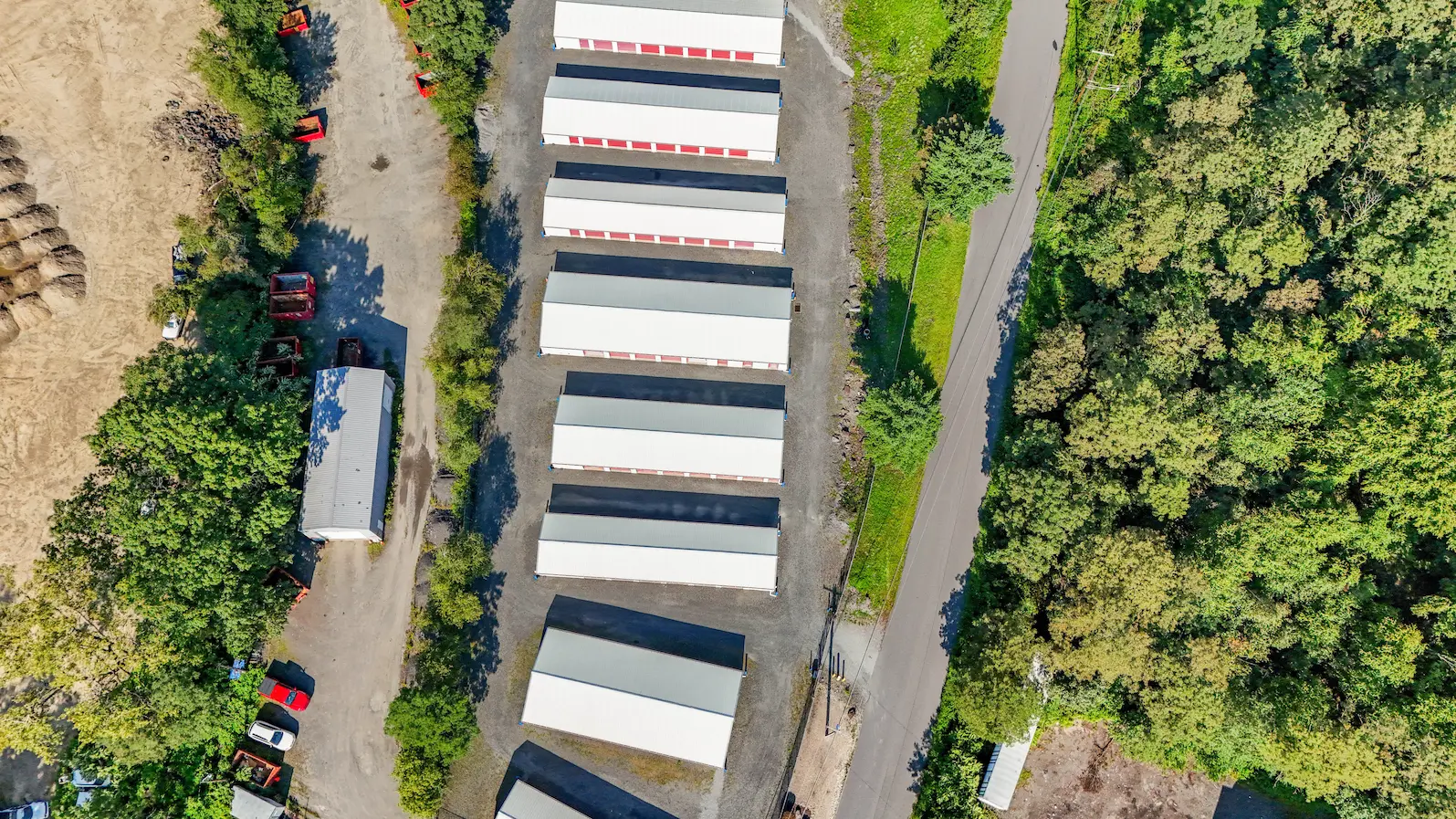 Aerial view of UrbanLock storage facility in Scranton showing linear arrangement of drive-up storage buildings surrounded by dense forest vegetation