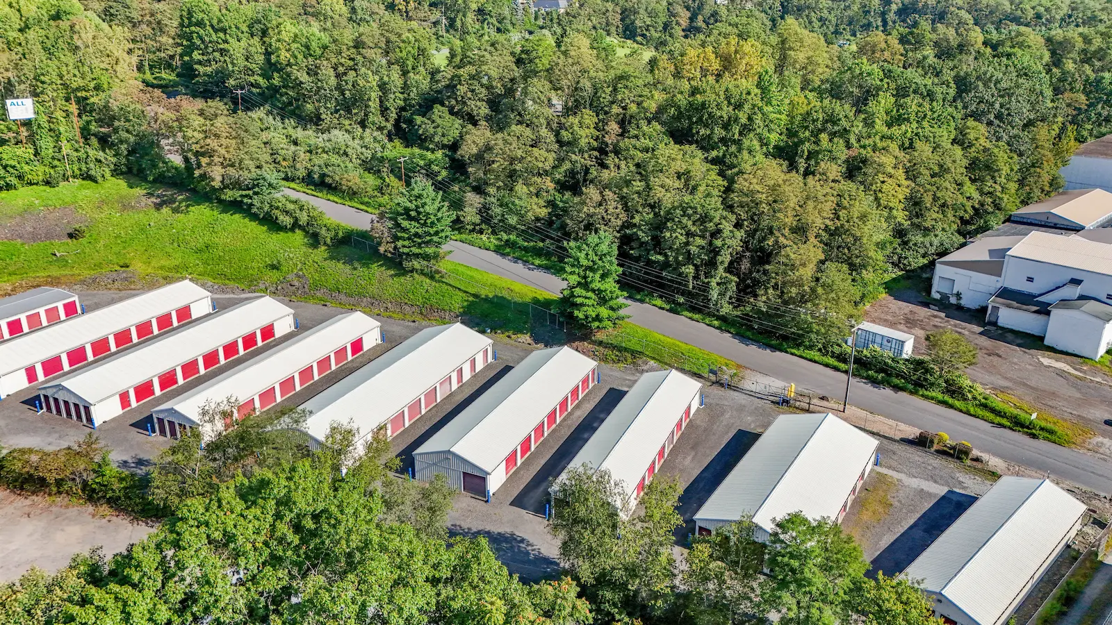 Aerial view of UrbanLock self-storage facility in Scranton with multiple storage buildings, access lanes, road frontage, and surrounding forested landscape