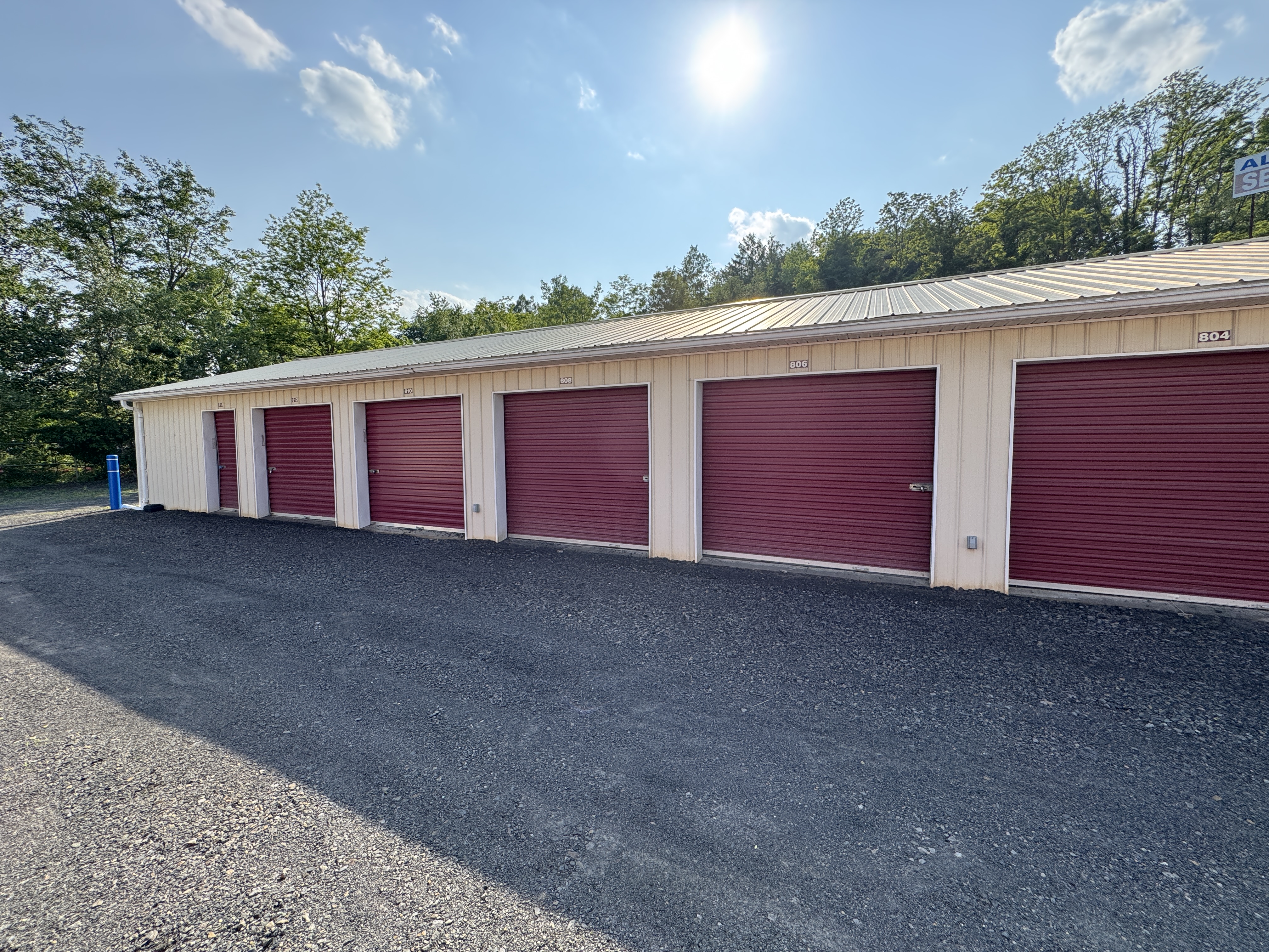 Large self-storage units with burgundy doors at UrbanLock Storage Scranton PA, well-maintained metal building with spacious drive-up access