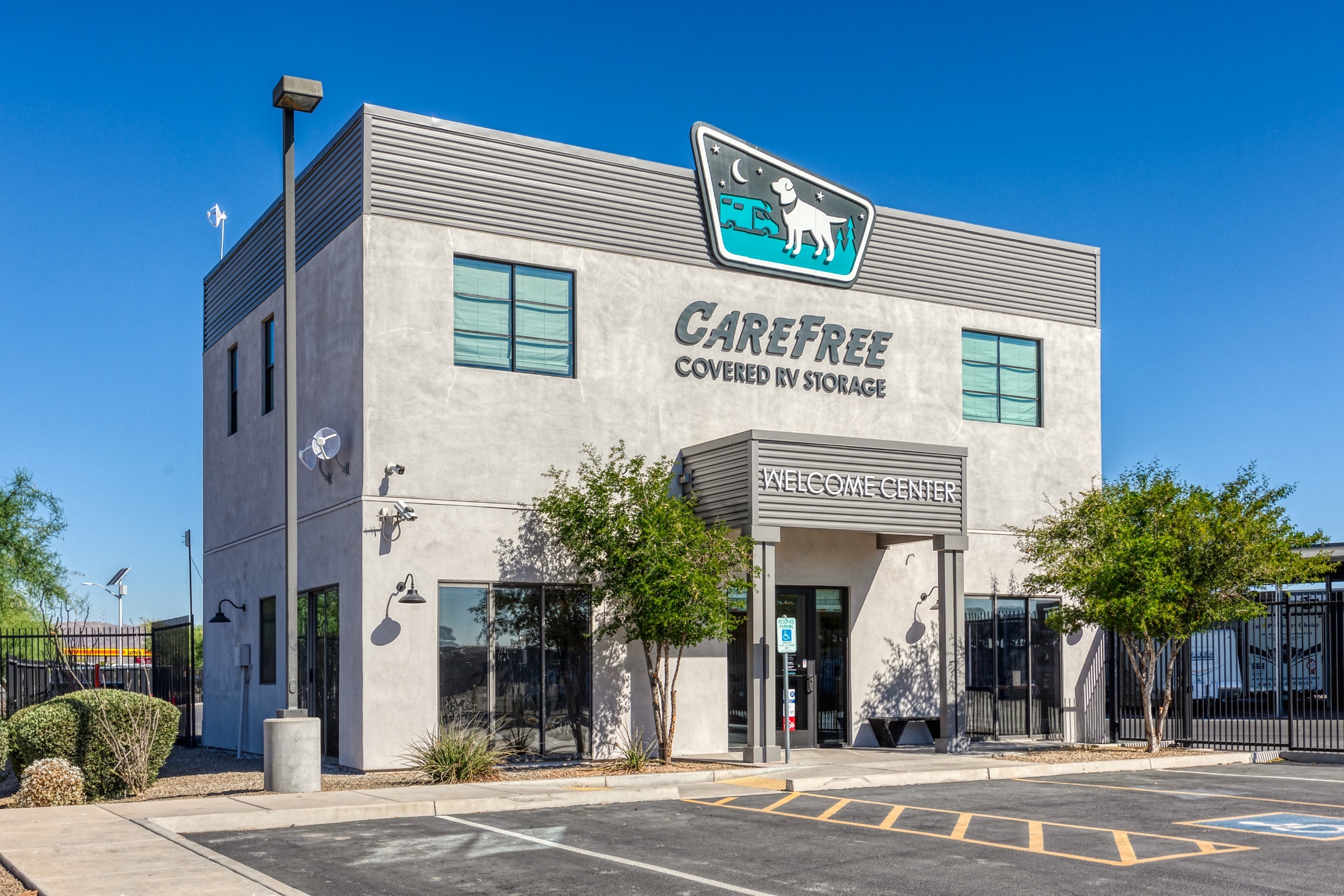 Front view of the Carefree Covered RV Storage welcome center in Chandler I-10 under a clear blue sky.
