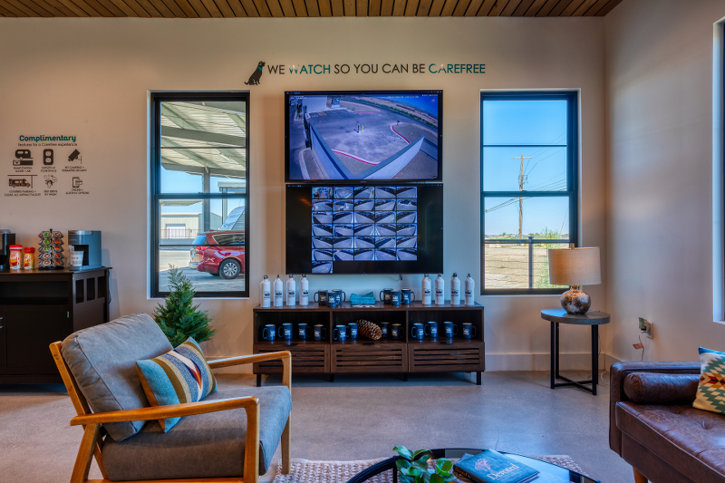 Interior of the Carefree Covered RV Storage welcome center in Maricopa, Arizona, showcasing real-time security camera monitoring, complimentary refreshments, and a cozy lounge—offering peace of mind and comfort for RV, boat, and trailer storage customers.