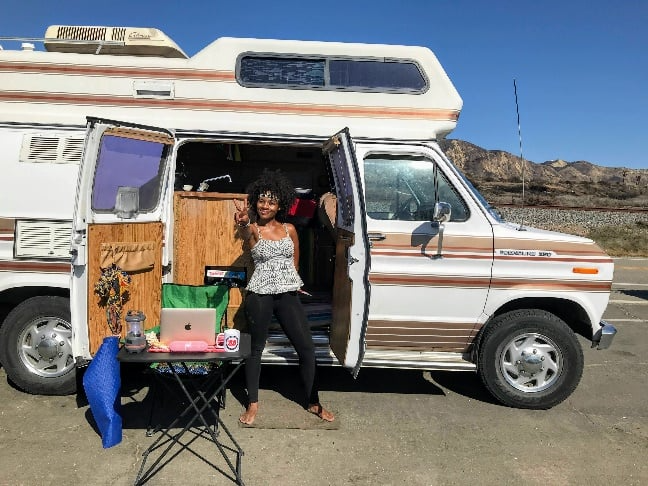 Woman standing outside her RV