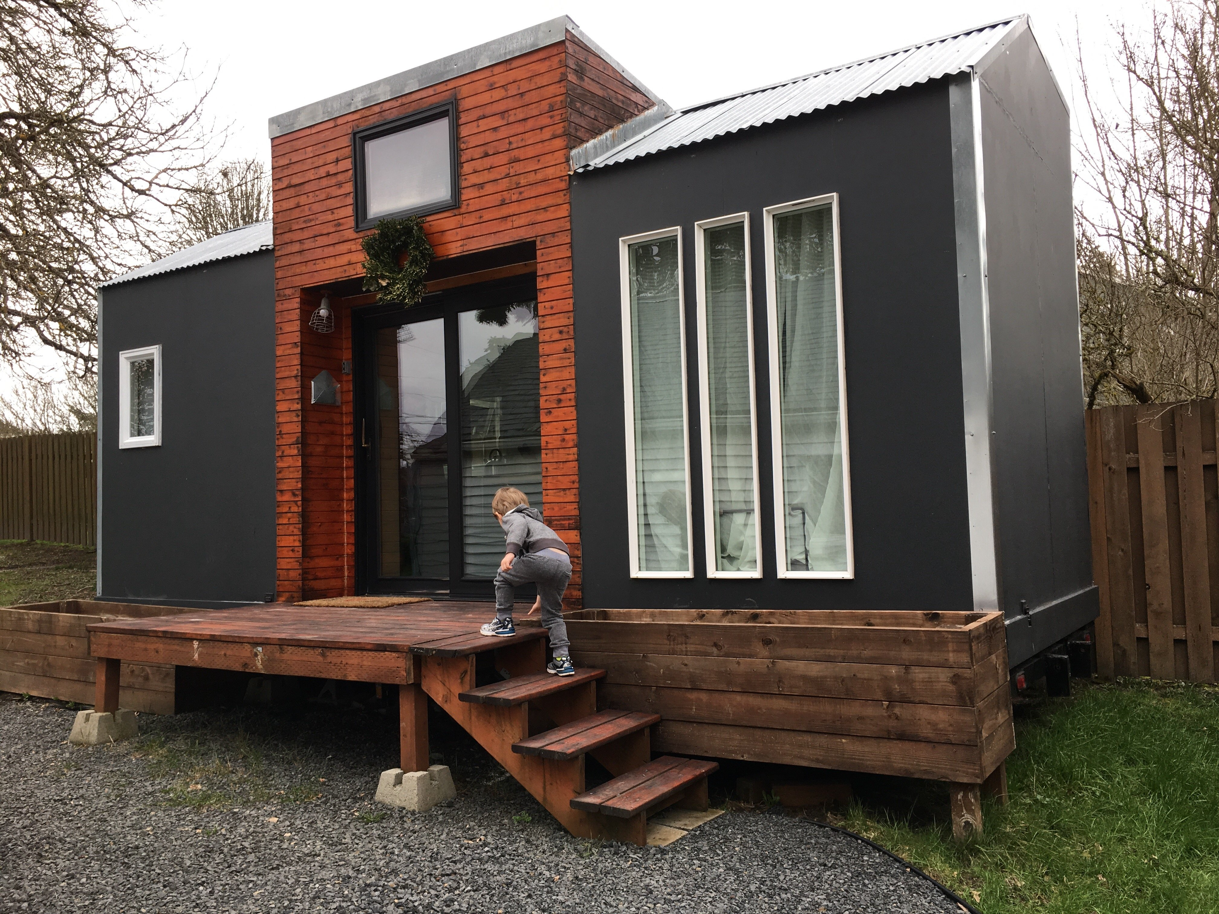 Child climbing stairs into a tiny house