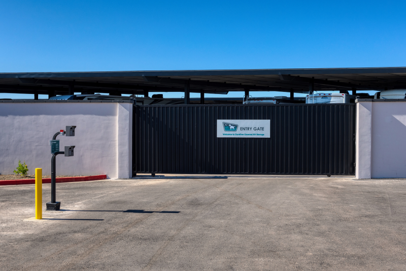Keypad entry gate with high walls at Carefree RV Storage in Surprise, AZ