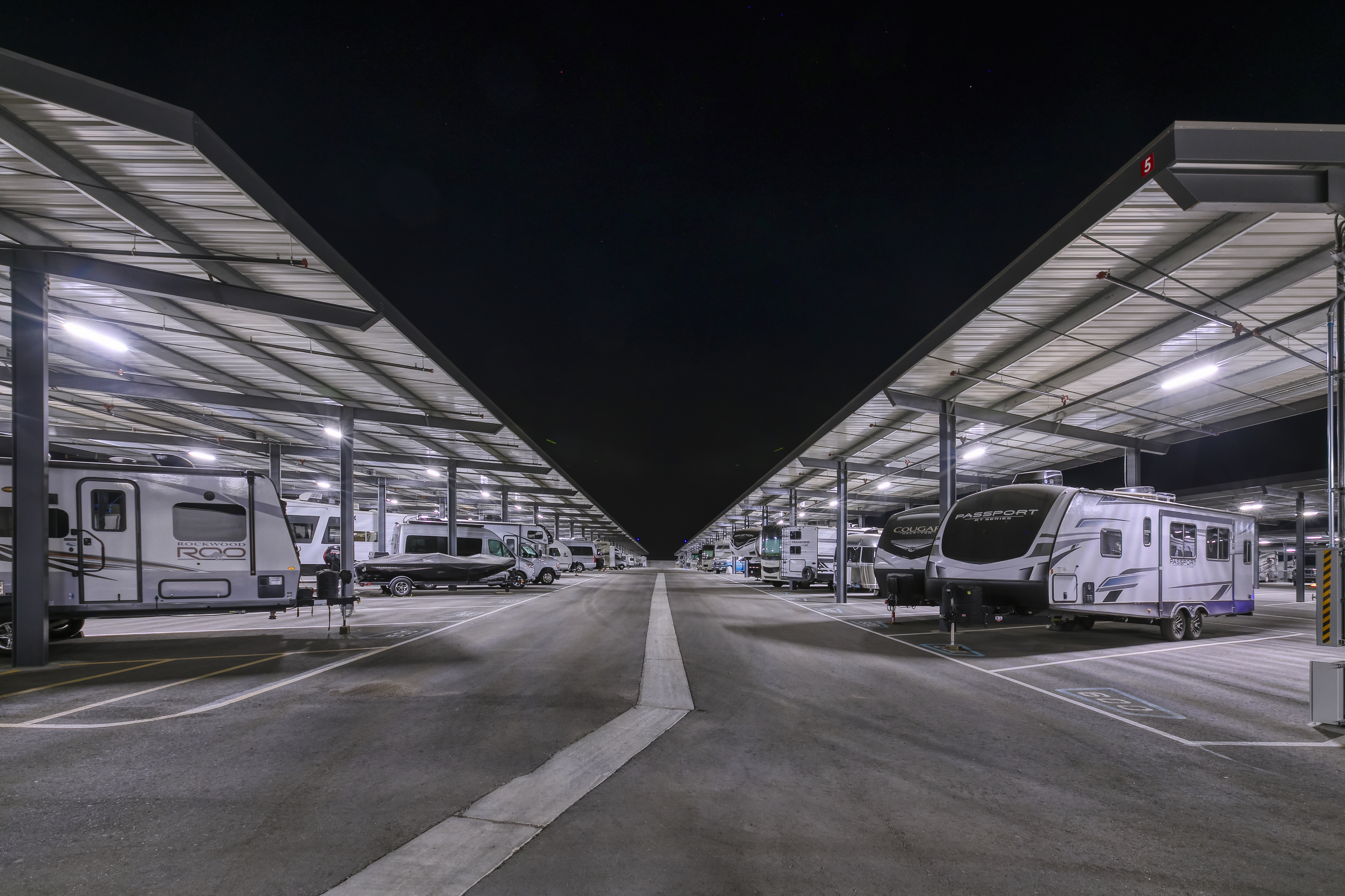 Well-lit covered RV storage spaces with nighttime security lighting in Surprise, Arizona