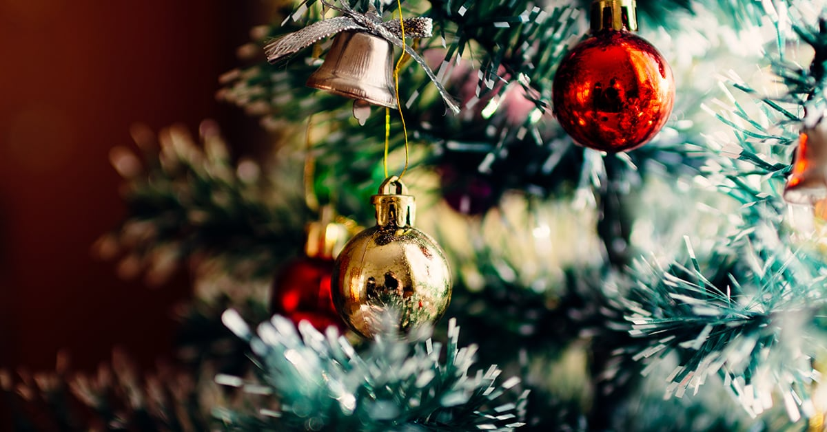 Close up photo of Christmas ornaments on a tree.