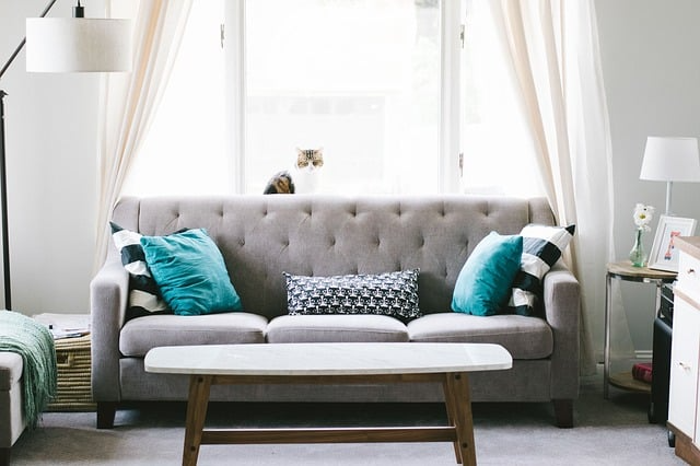 Picture of a front room with couch, coffee table, and lamps