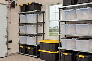 A picture of shelving filled with plastic storage containers in a garage.