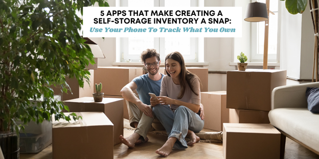 A couple sitting on the floor around boxes for self-storage using an app on their phone.