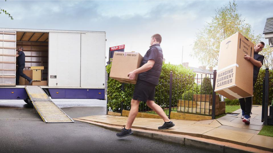 Movers moving boxes into a truck