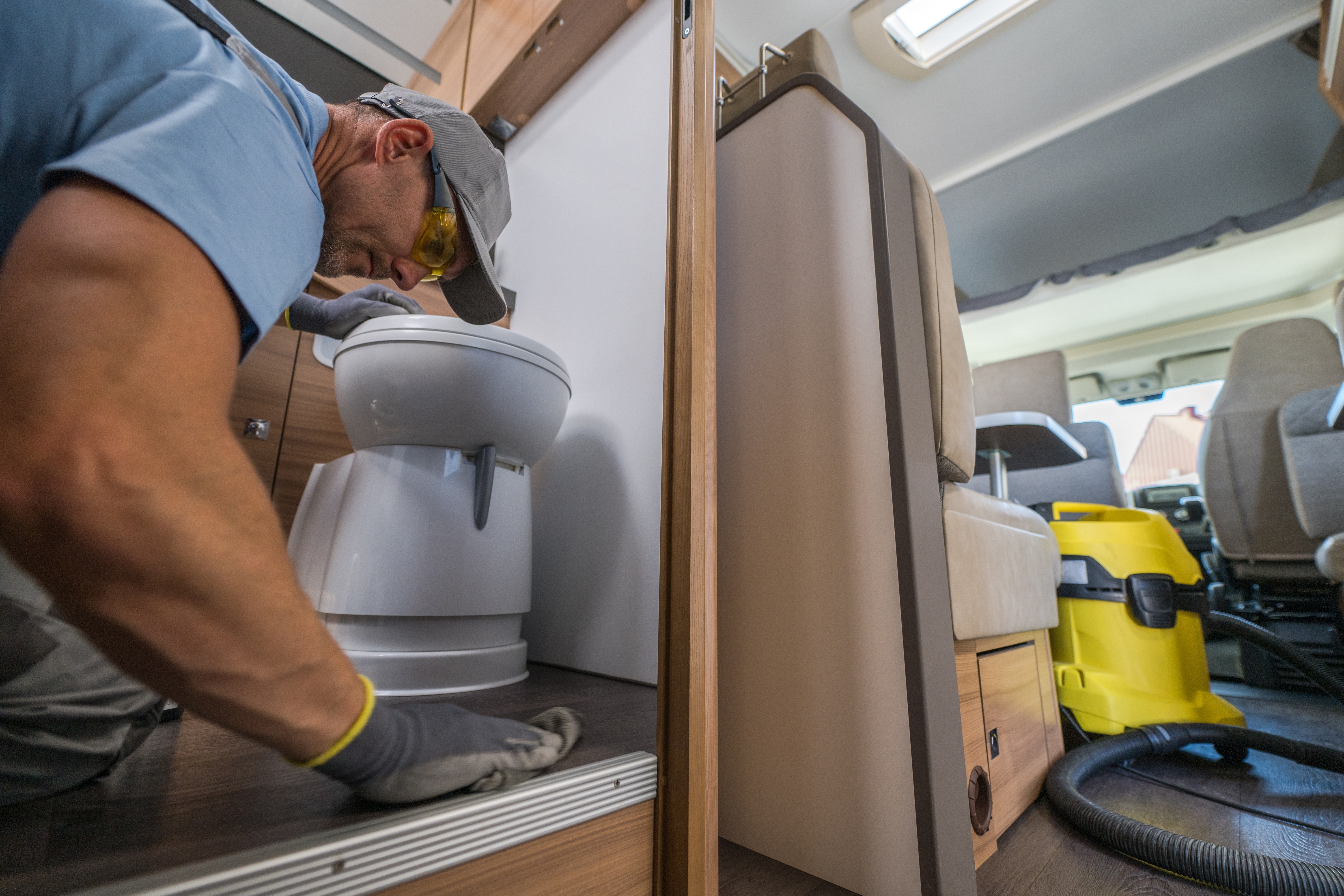 Man cleaning his RV to prepare for winter RV storage