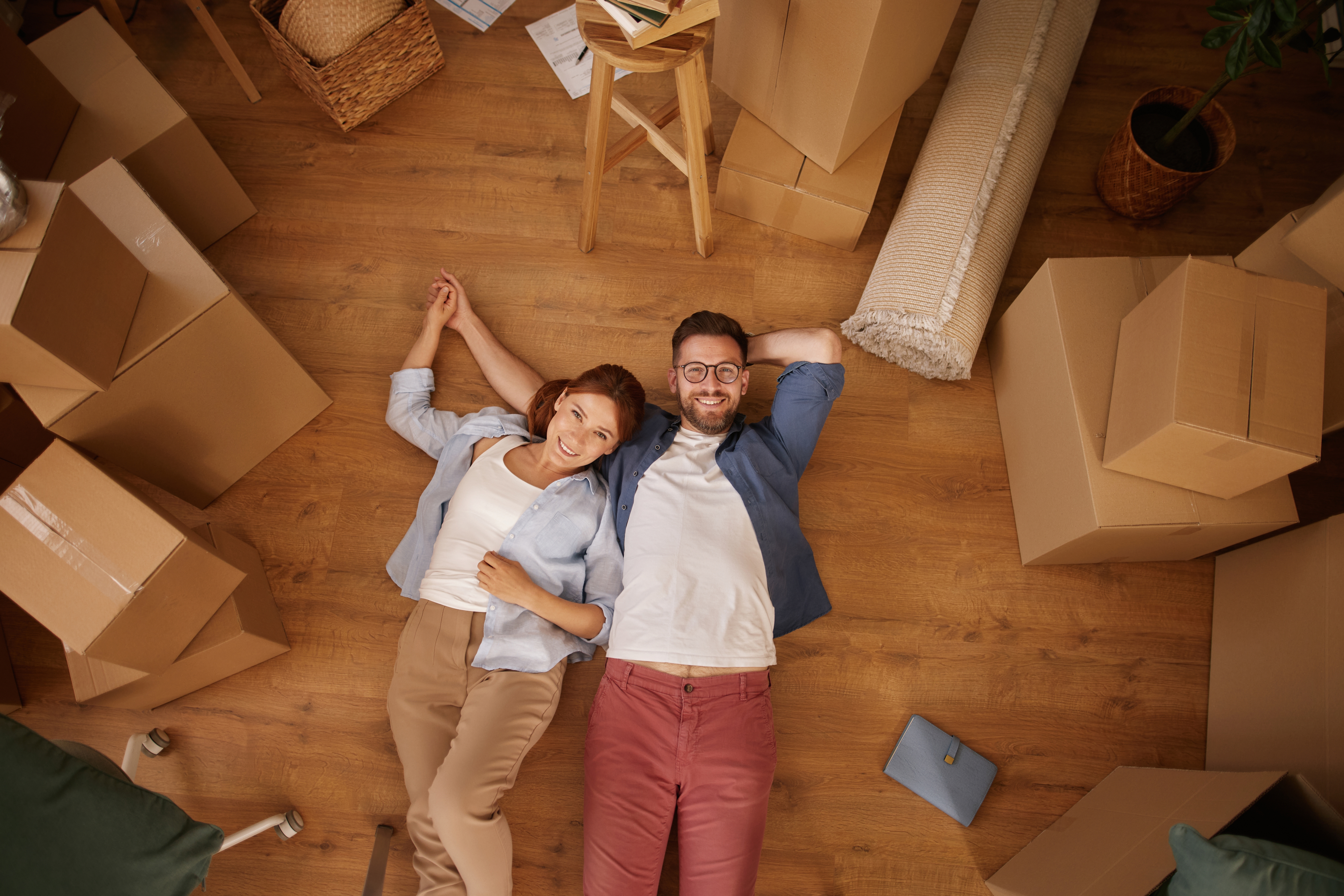 Couple lying on the floor with boxes ready for their Cincinnati storage unit
