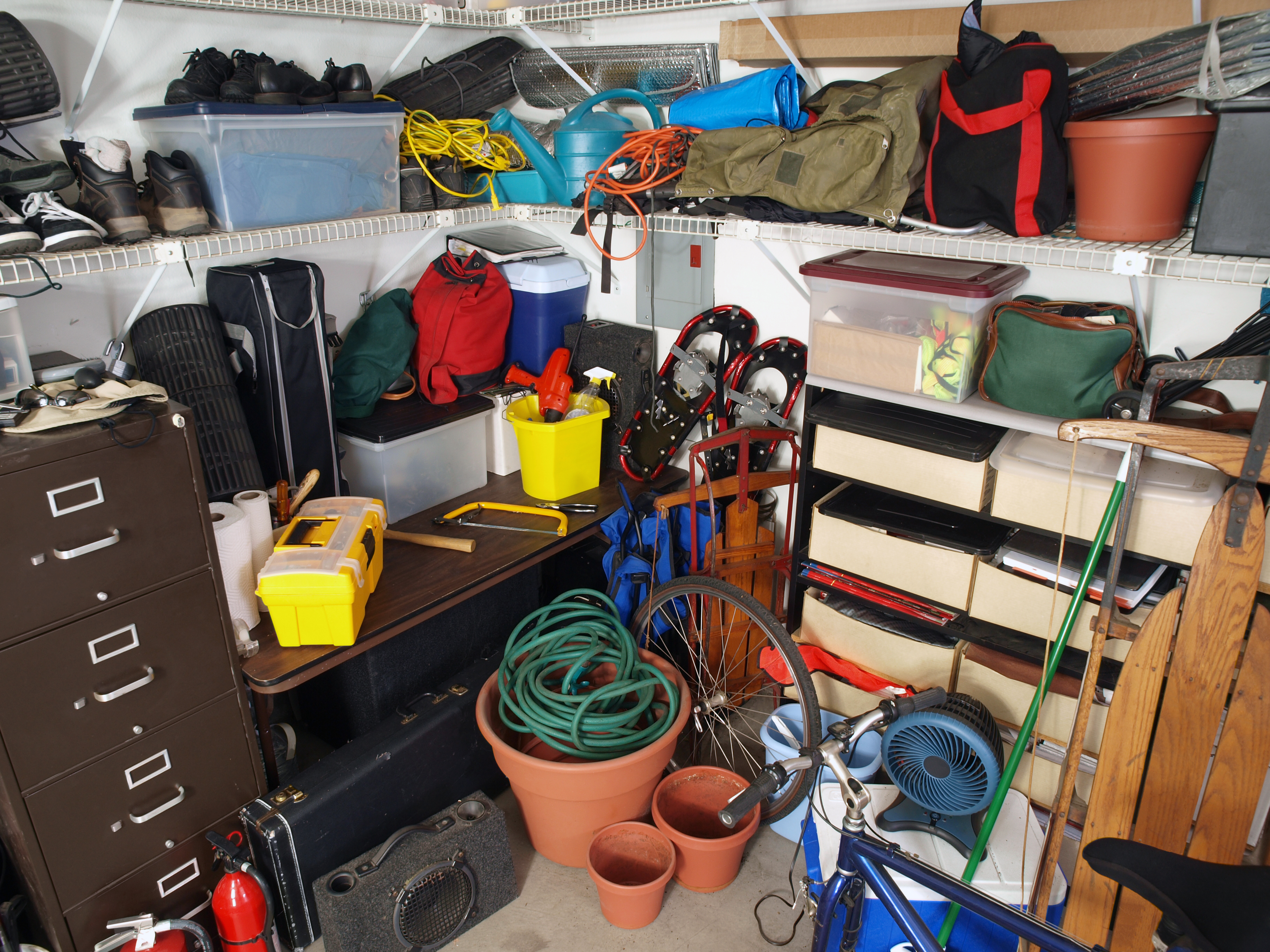 A garage full of stuff that is not very well organized 