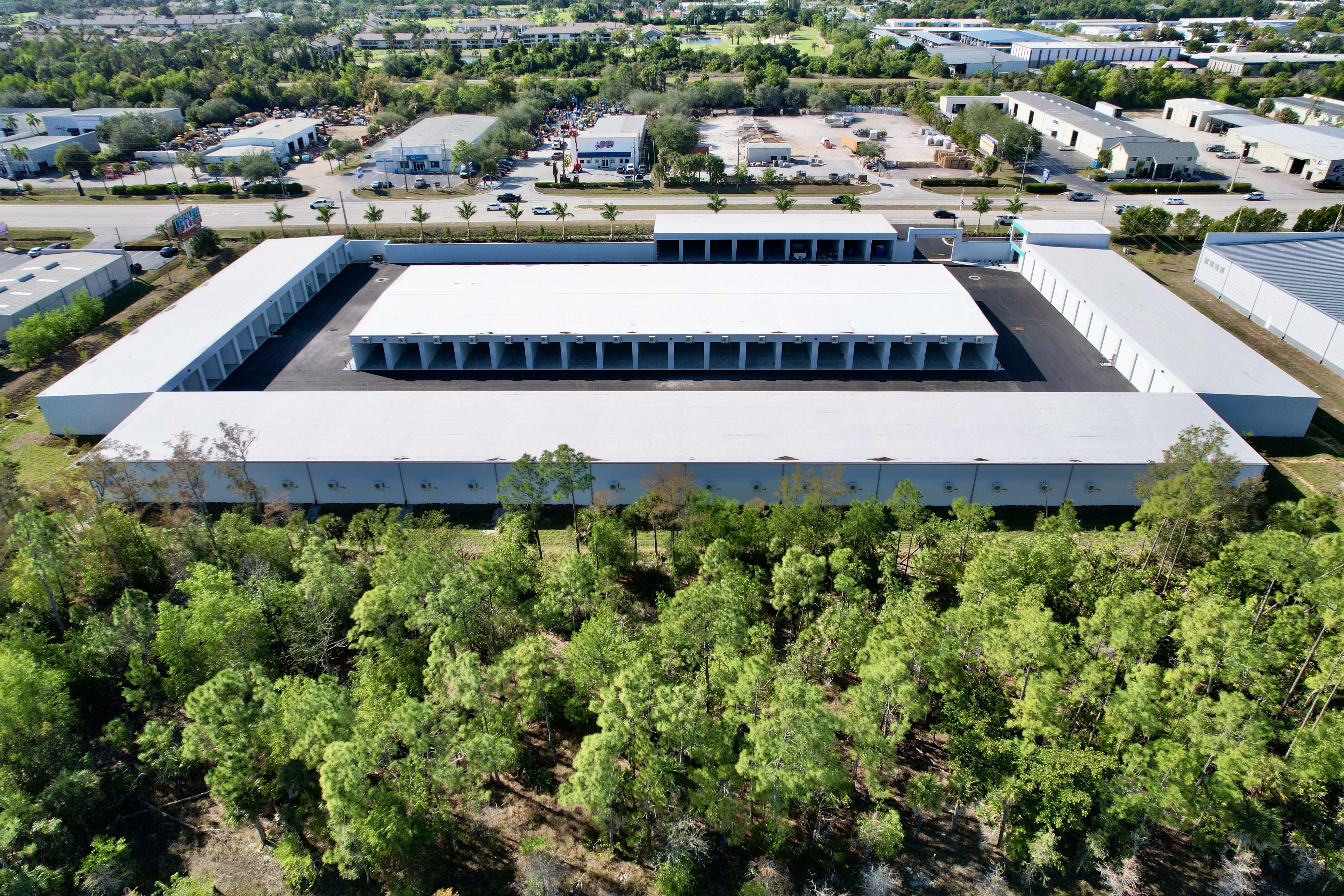 Full aerial view of Metro-Maxx RV and boat storage facility showing multiple long climate-controlled buildings, wide drive aisles, and secure perimeter in Fort Myers, Florida